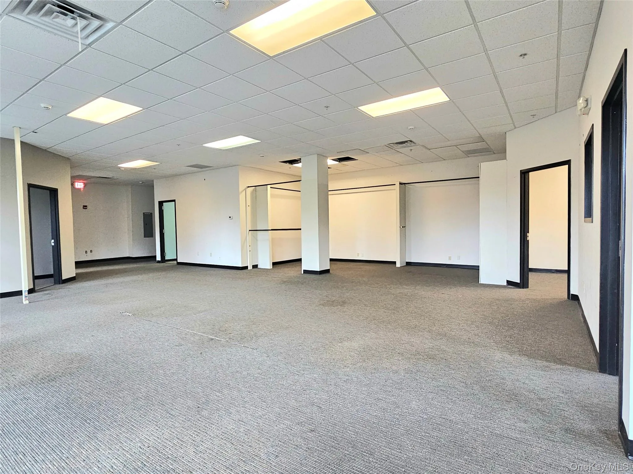 Spare room with light carpet and a drop ceiling Spare room with light carpet and a drop ceiling