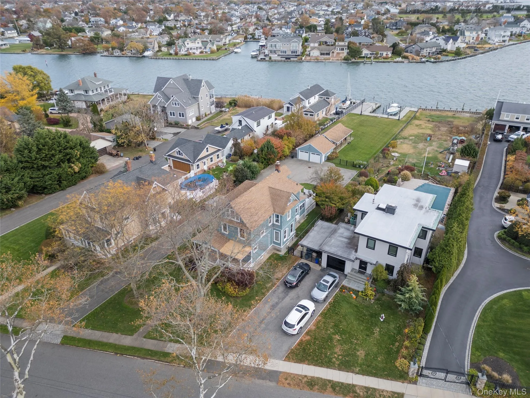 Aerial perspective of suburban area with a nearby body of water Aerial perspective of suburban area with a nearby body of water