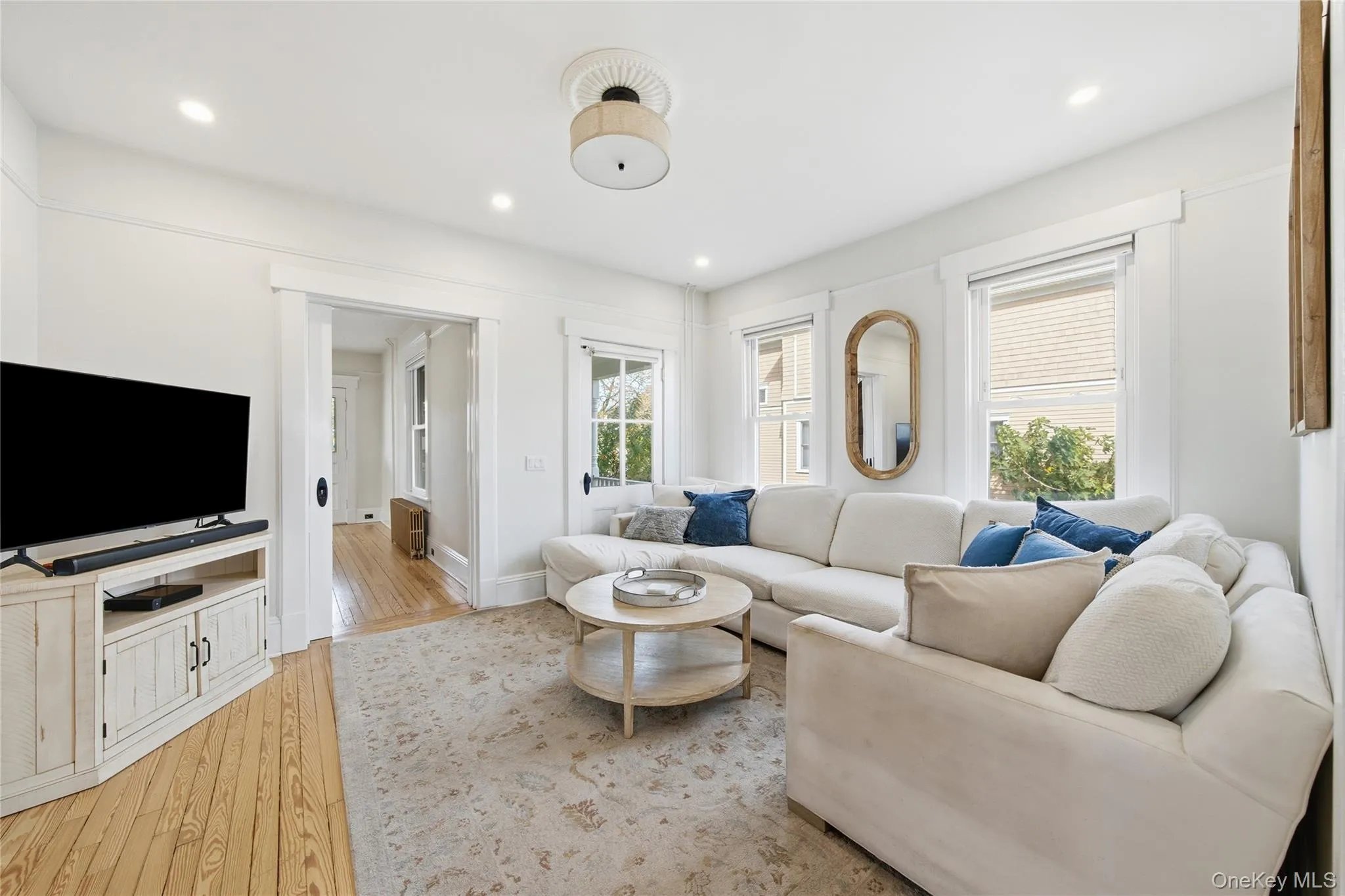 Living area with light wood-style floors, recessed lighting, and plenty of natural light Living area with light wood-style floors, recessed lighting, and plenty of natural light