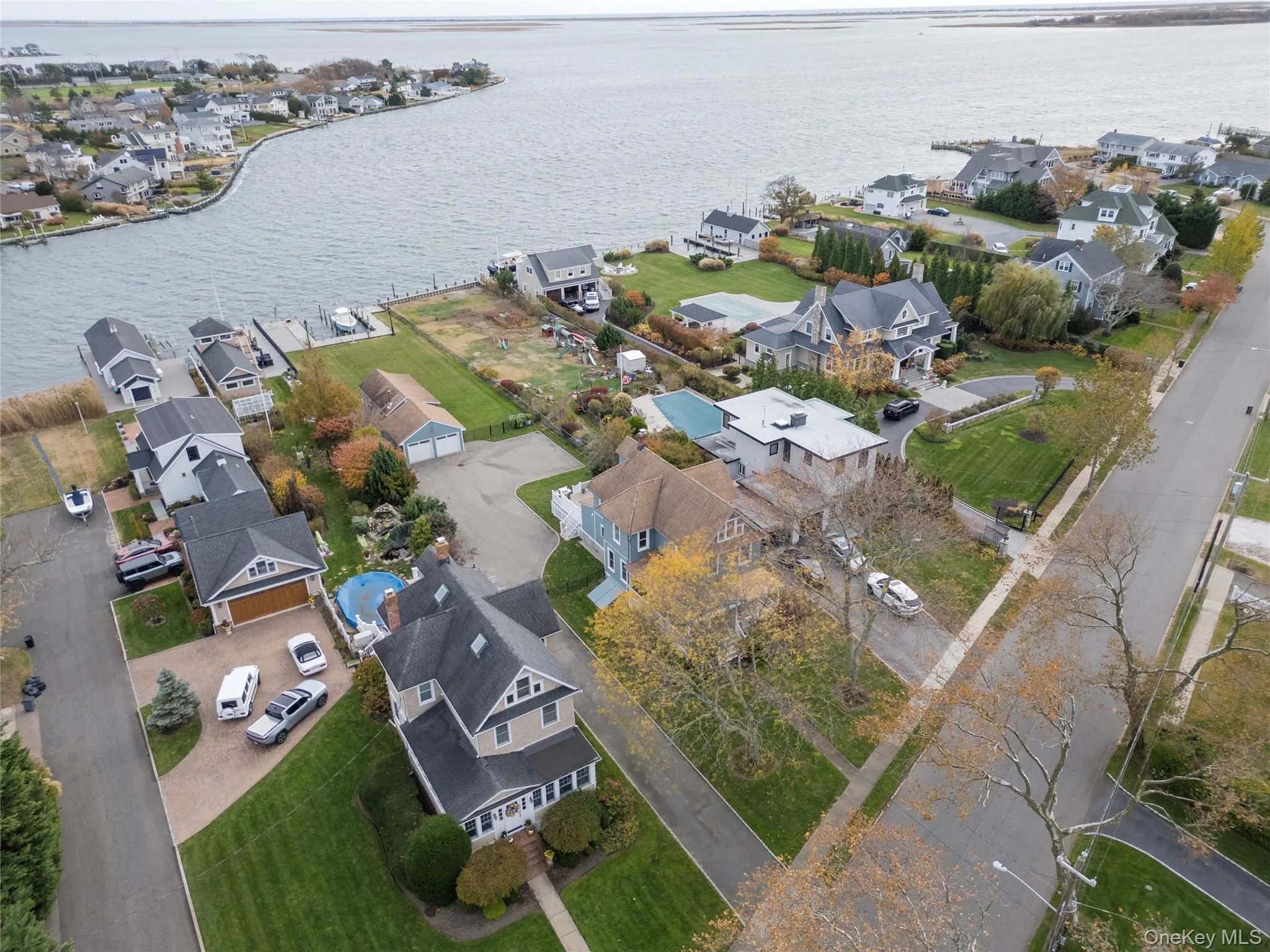 Aerial view of property and surrounding area with nearby suburban area and a large body of water Aerial view of property and surrounding area with nearby suburban area and a large body of water
