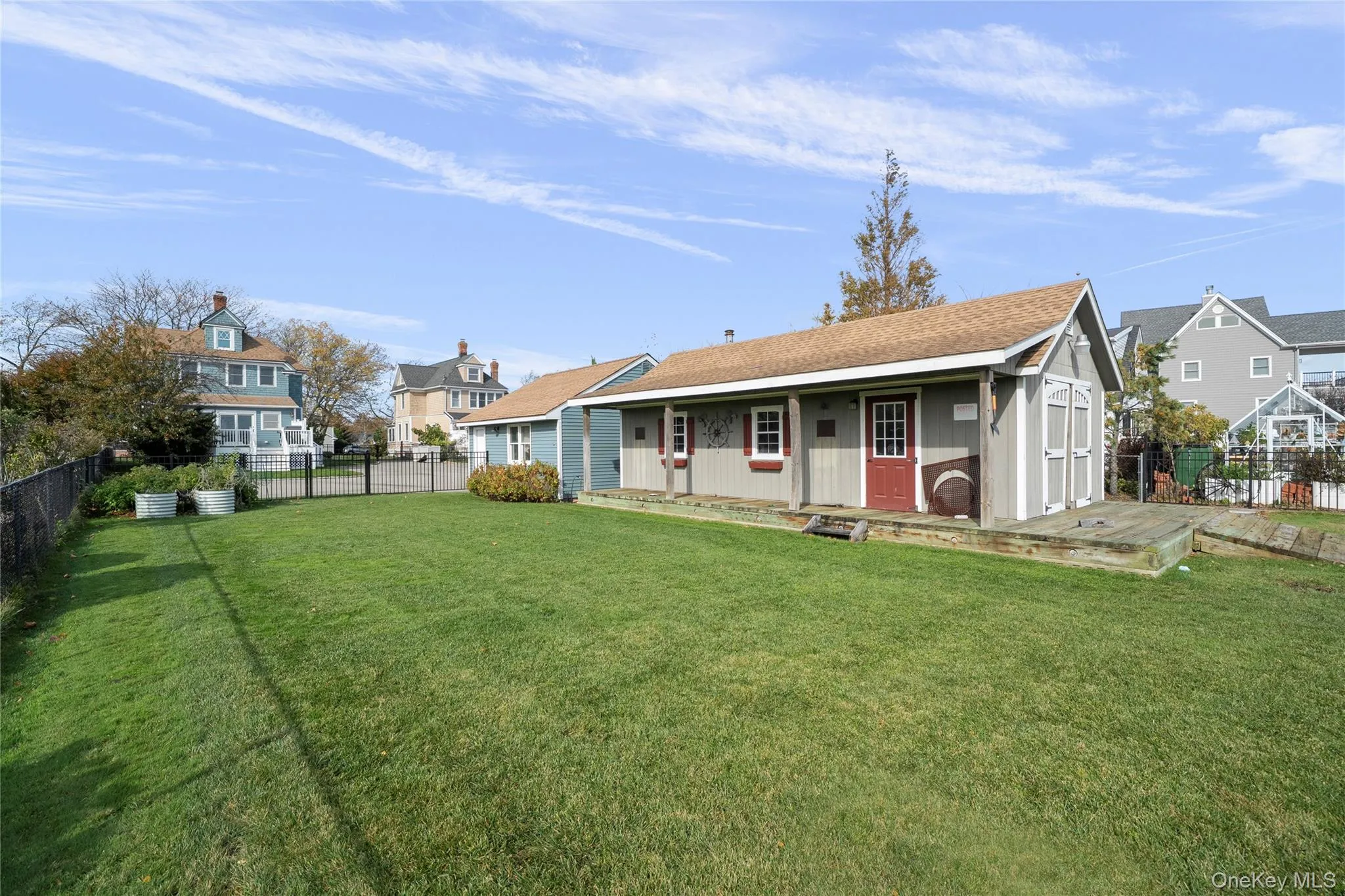 Back of property with an outbuilding, a shingled roof, and a residential view Back of property with an outbuilding, a shingled roof, and a residential view