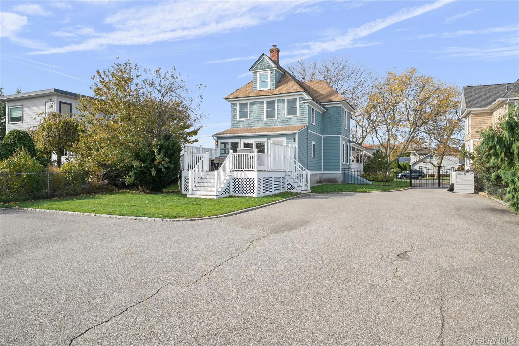 Shingle-style home with a chimney and a deck Shingle-style home with a chimney and a deck