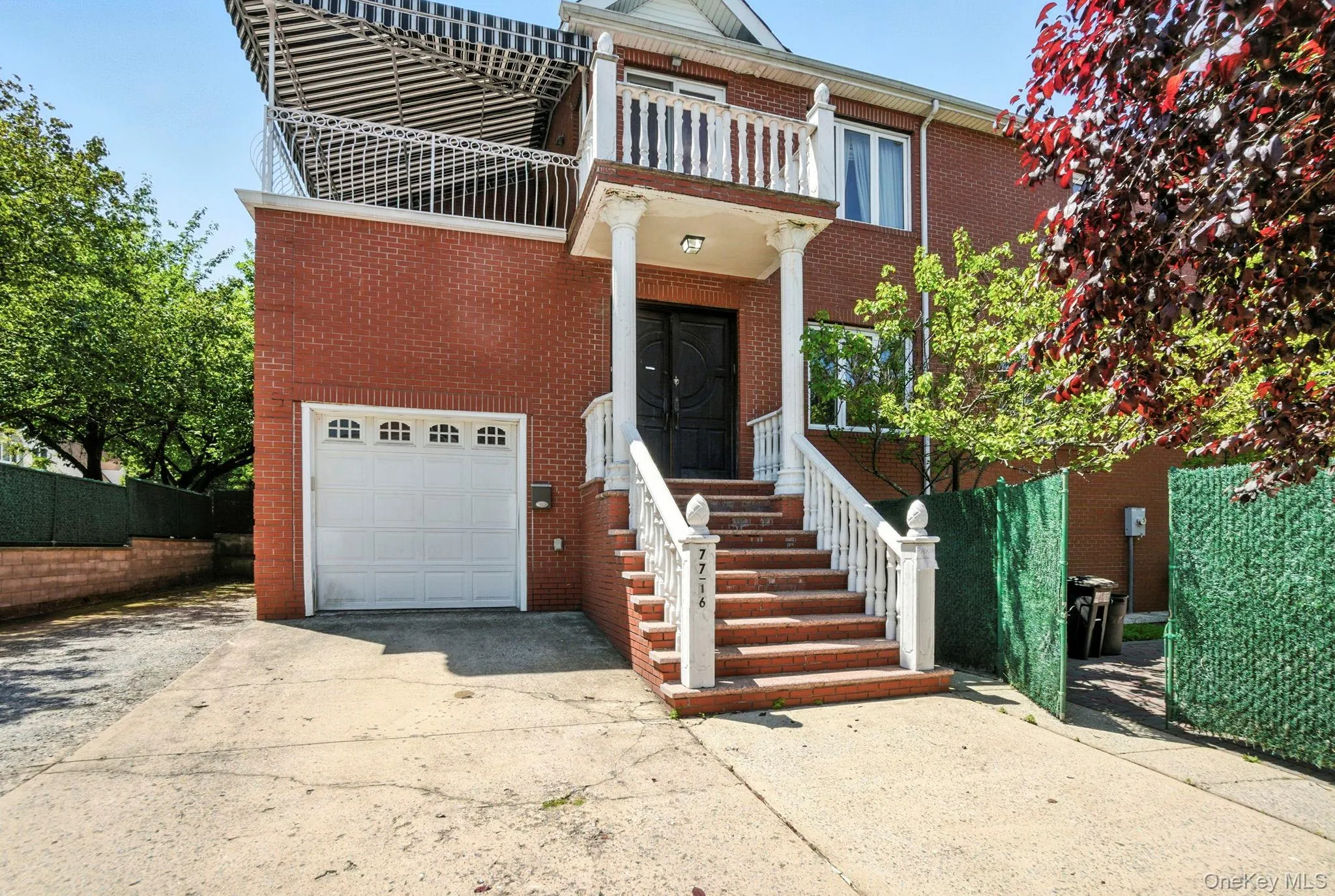 View of front facade with an attached garage, driveway, and brick siding View of front facade with an attached garage, driveway, and brick siding