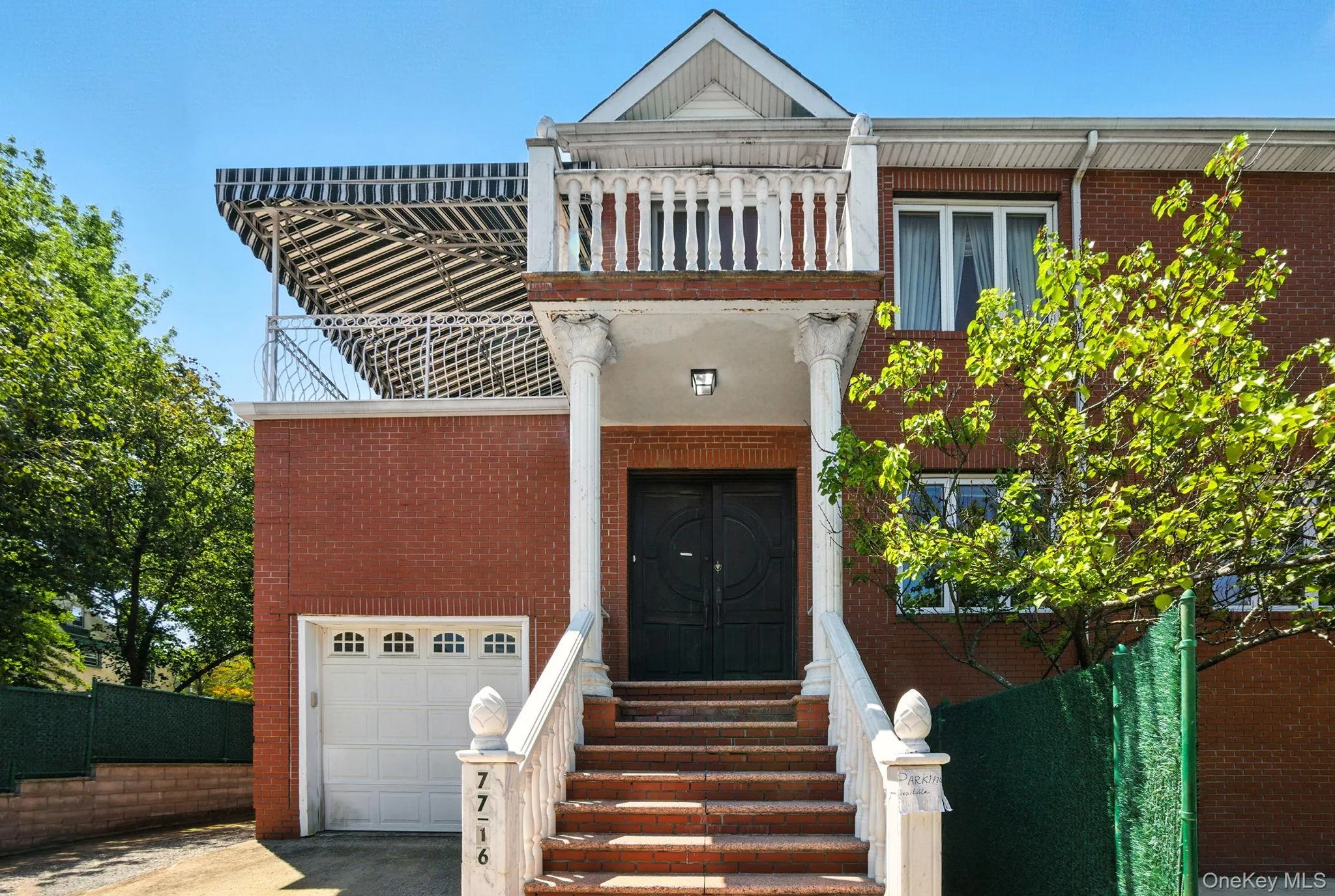 View of front of home with brick siding, a garage, and driveway View of front of home with brick siding, a garage, and driveway