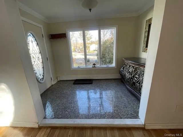 Foyer with a baseboard heating unit and ornamental molding Foyer with a baseboard heating unit and ornamental molding