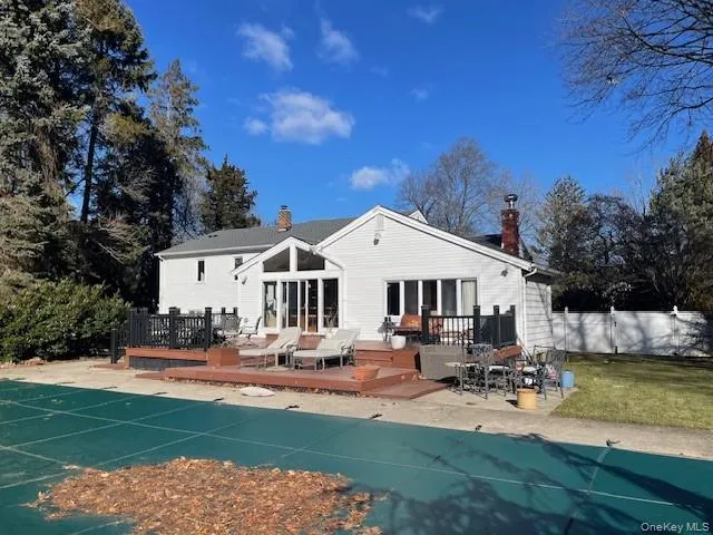 Rear view of property with a swimming pool side deck Rear view of property with a swimming pool side deck
