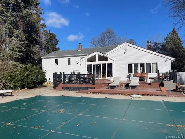 Rear view of house with a pool side deck Rear view of house with a pool side deck