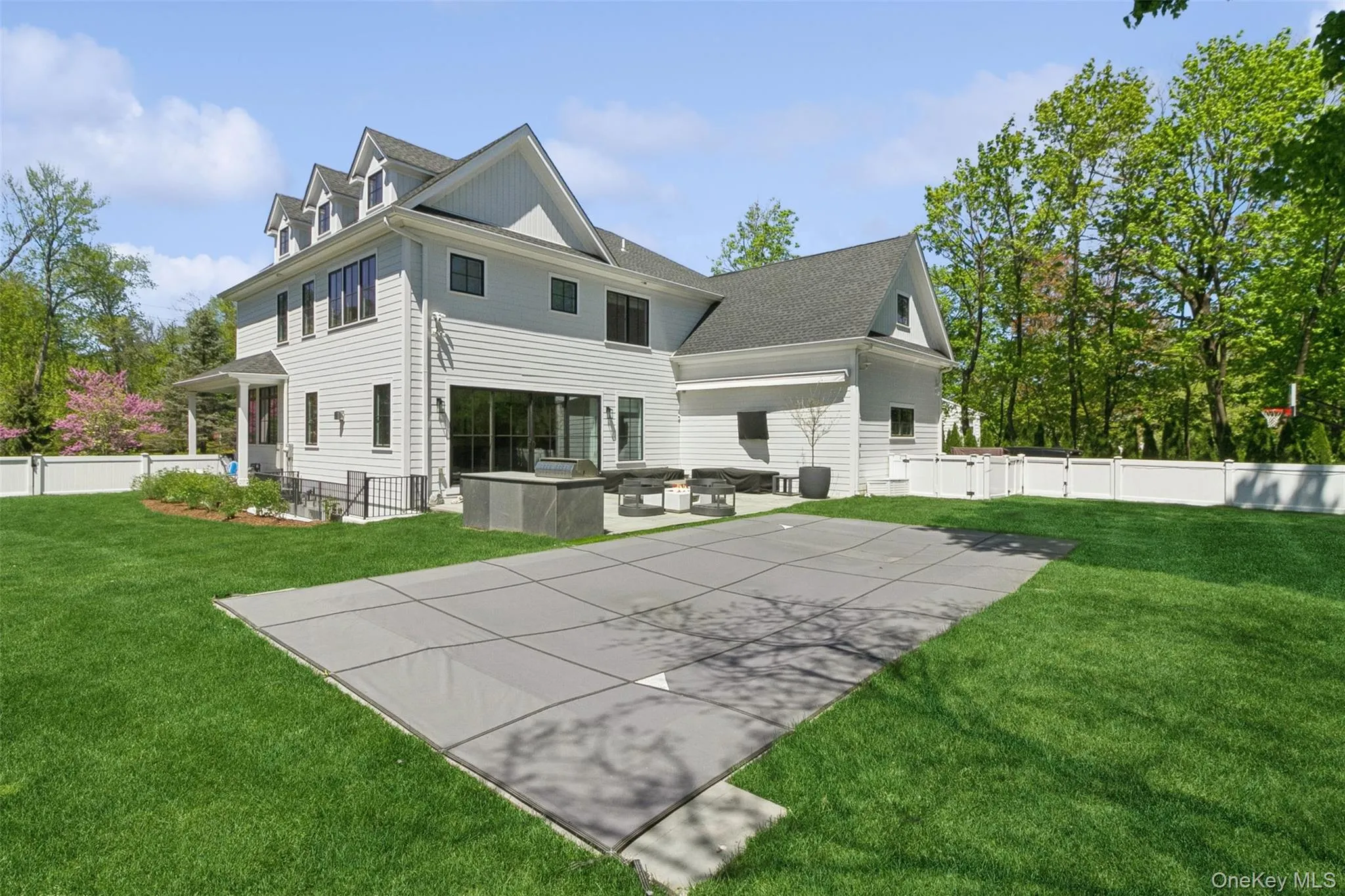 Rear view of house with a patio area, a fenced backyard, and pool Rear view of house with a patio area, a fenced backyard, and pool