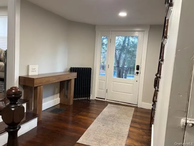 Entryway with wood finished floors, radiator heating unit, and recessed lighting Entryway with wood finished floors, radiator heating unit, and recessed lighting