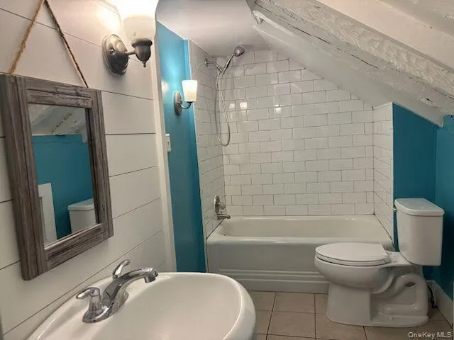 Bathroom with light tile patterned floors and washtub / shower combination Bathroom with light tile patterned floors and washtub / shower combination
