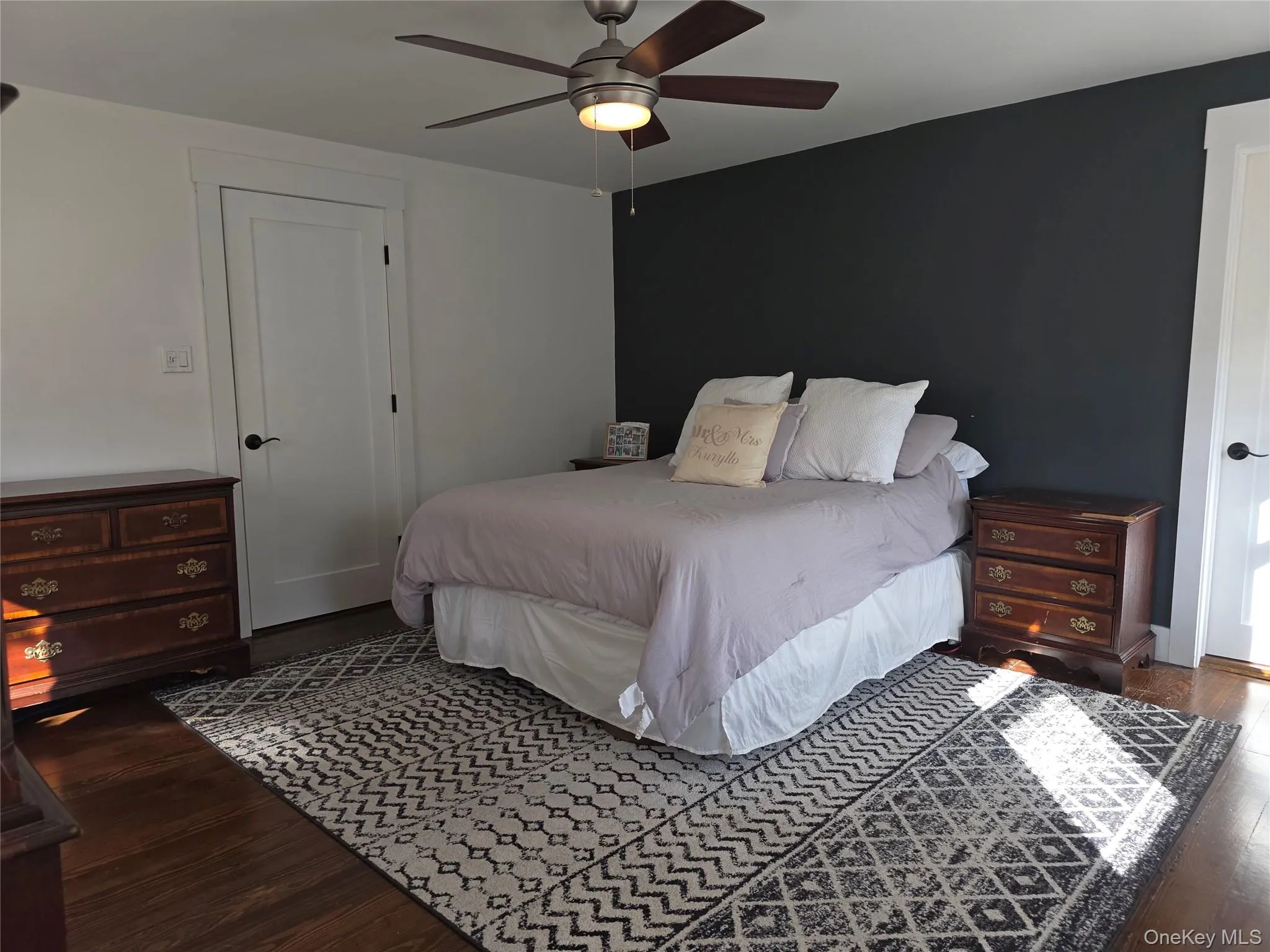 Bedroom with dark wood finished floors and ceiling fan Bedroom with dark wood finished floors and ceiling fan