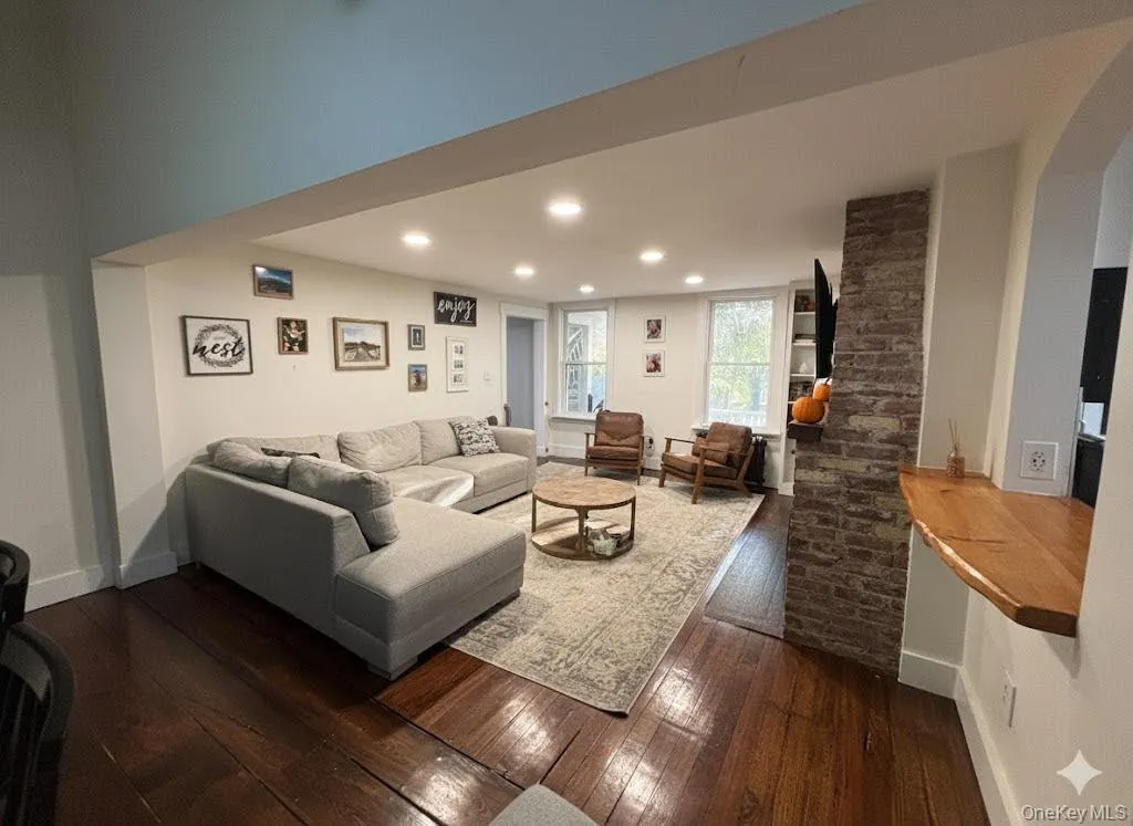 Living room featuring dark wood-style floors and recessed lighting Living room featuring dark wood-style floors and recessed lighting