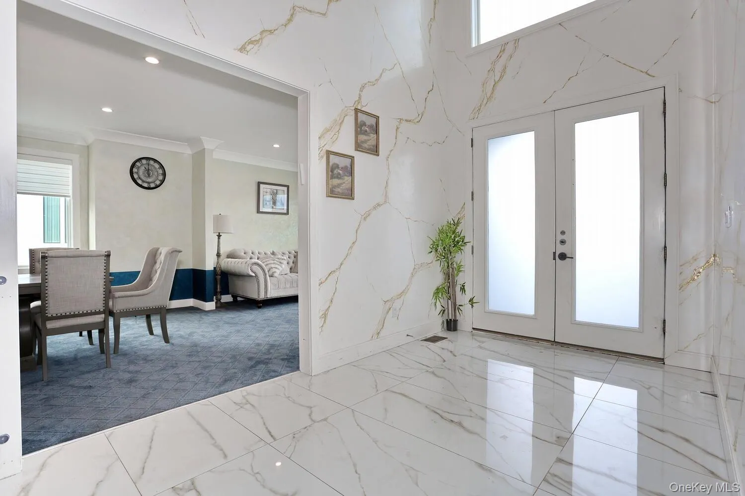 Entrance foyer with french doors, marble tiled floors, recessed lighting, and ornamental molding Entrance foyer with french doors, marble tiled floors, recessed lighting, and ornamental molding