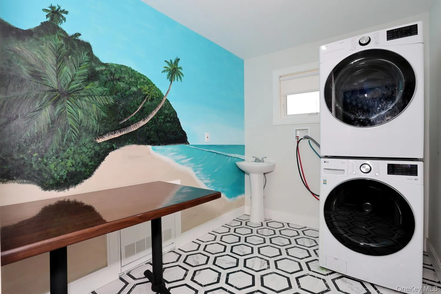 Laundry room with stacked washer / dryer and tile patterned floors Laundry room with stacked washer / dryer and tile patterned floors