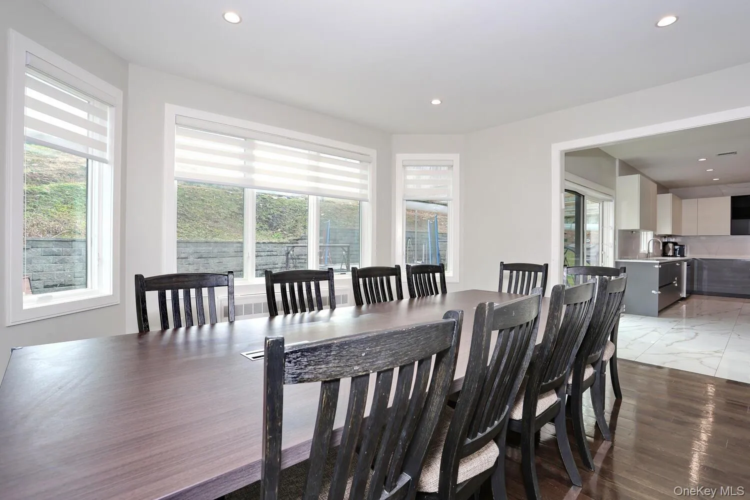 Dining area with light wood-type flooring and recessed lighting Dining area with light wood-type flooring and recessed lighting