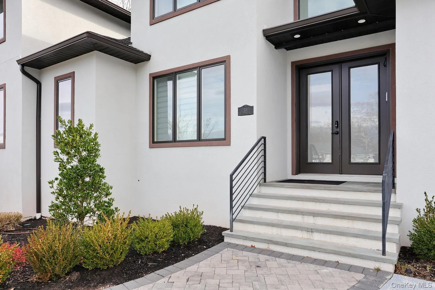 Doorway to property featuring stucco siding and french doors Doorway to property featuring stucco siding and french doors