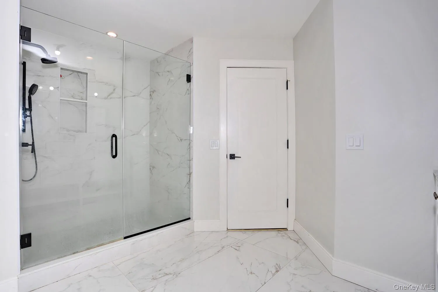 Bathroom with marble finish flooring, a marble finish shower, and recessed lighting Bathroom with marble finish flooring, a marble finish shower, and recessed lighting