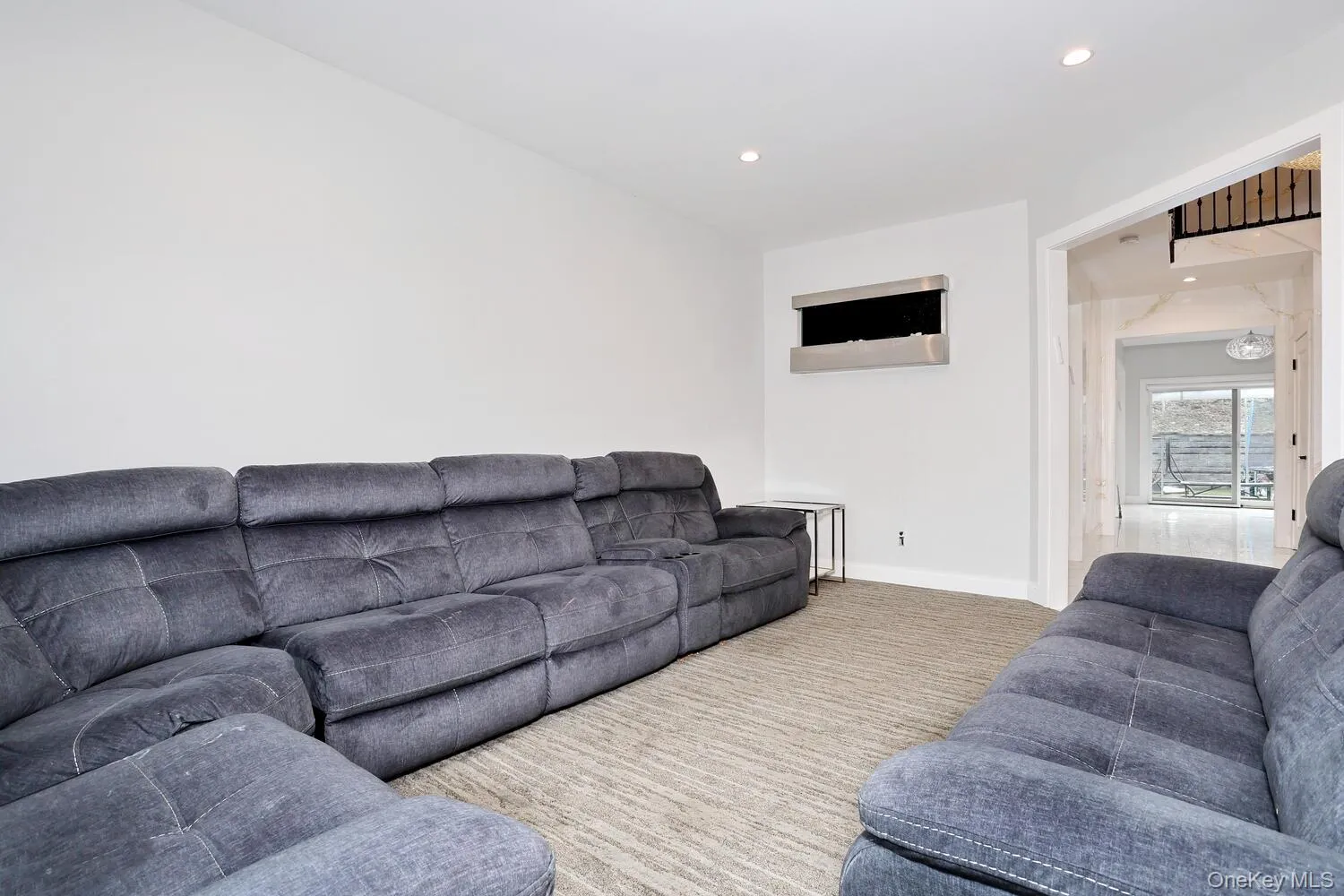 Living area with recessed lighting and carpet floors Living area with recessed lighting and carpet floors