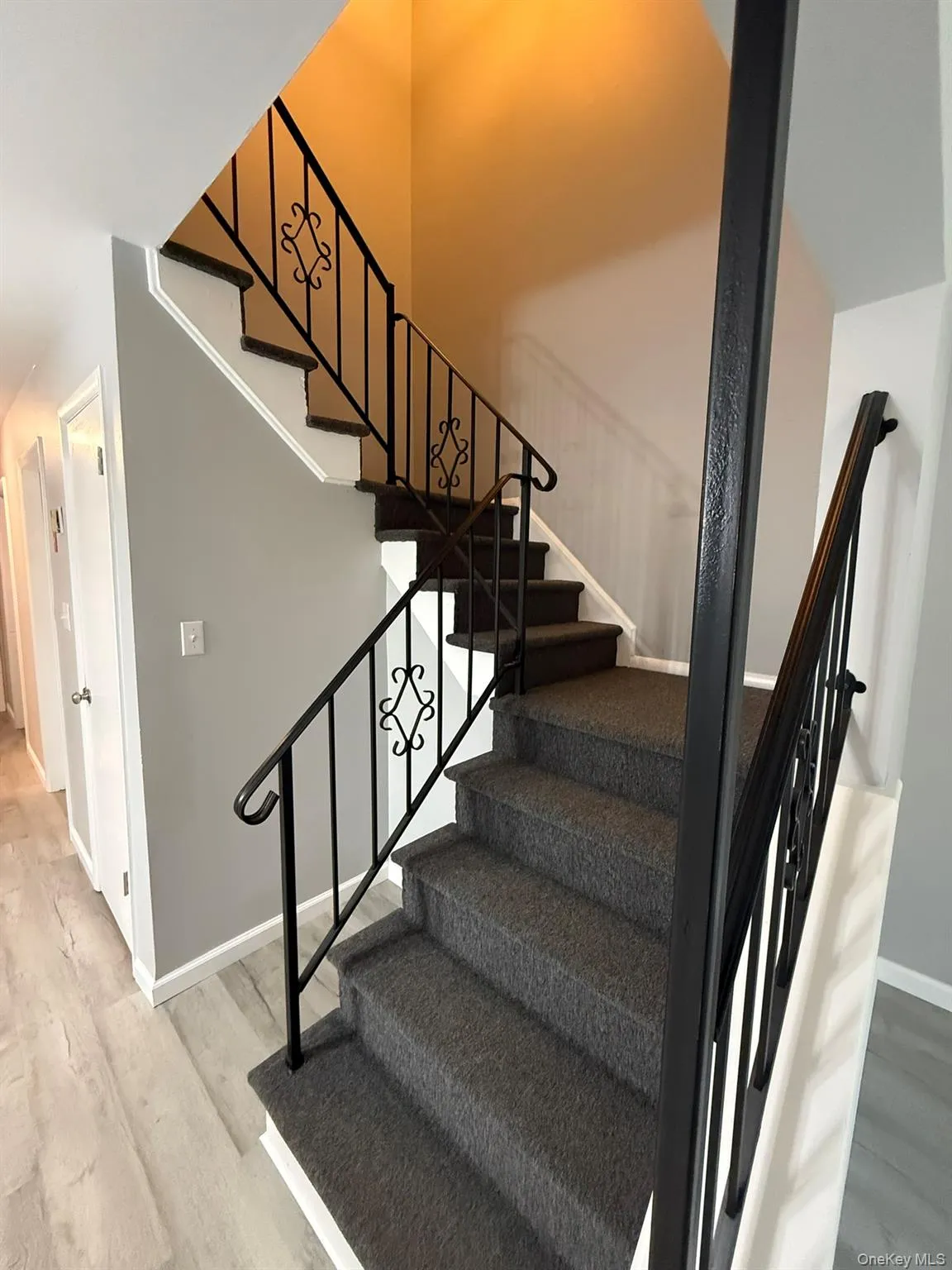 Staircase featuring baseboards and wood finished floors Staircase featuring baseboards and wood finished floors