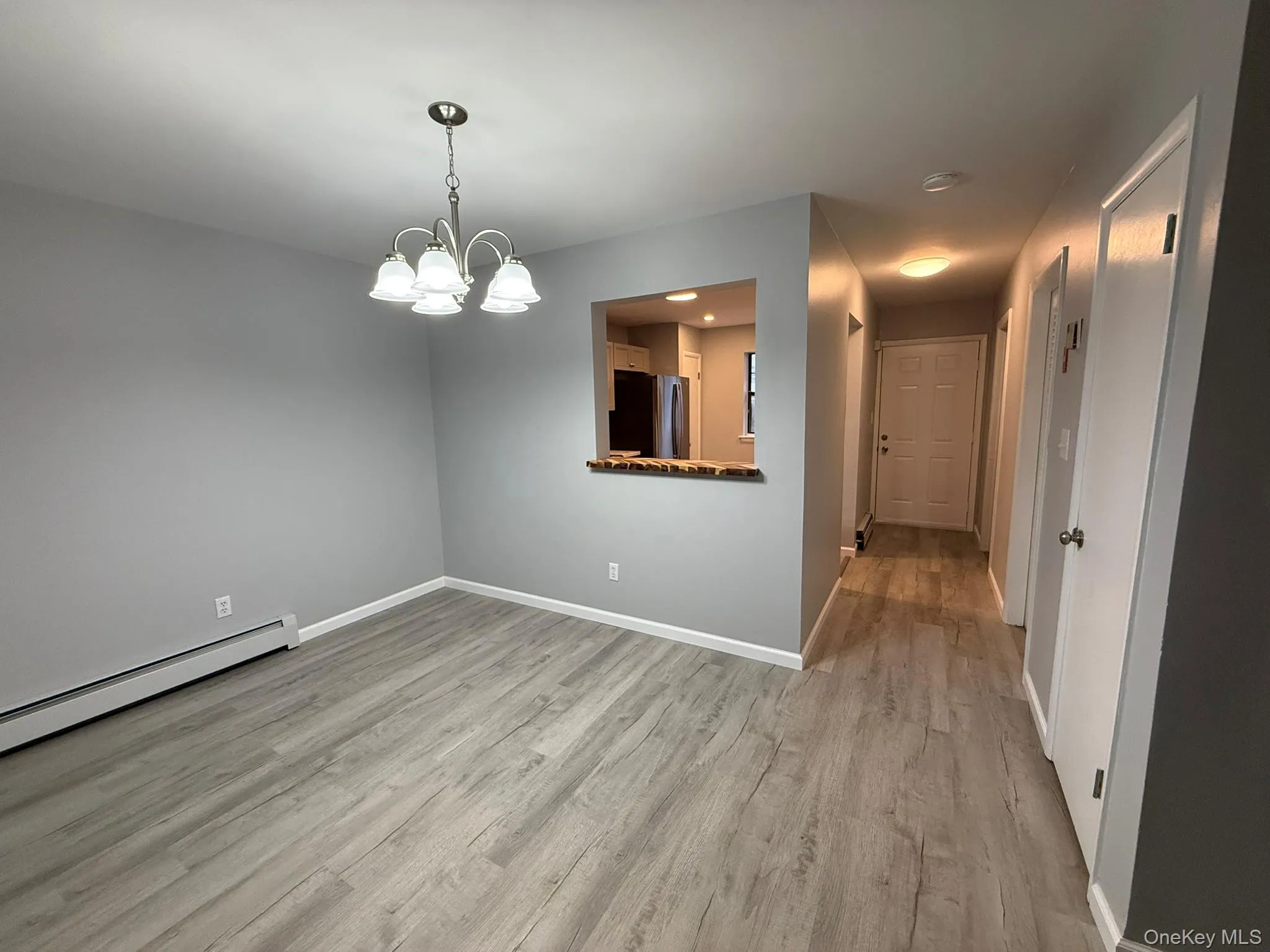 Dining area looking into the kitchen and entrance foyer Dining area looking into the kitchen and entrance foyer