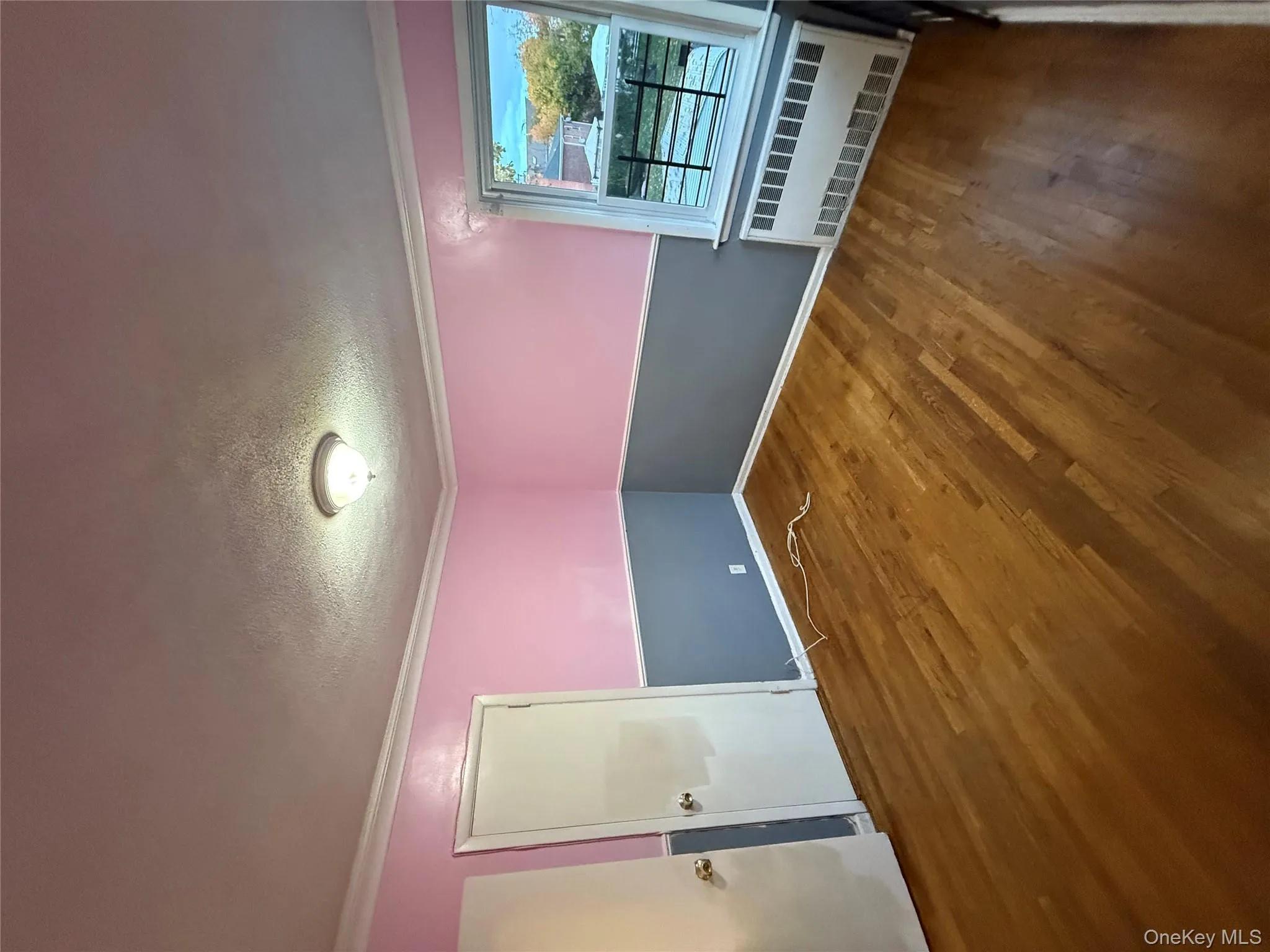 Spare room featuring ornamental molding, radiator heating unit, dark wood finished floors, and a textured ceiling Spare room featuring ornamental molding, radiator heating unit, dark wood finished floors, and a textured ceiling