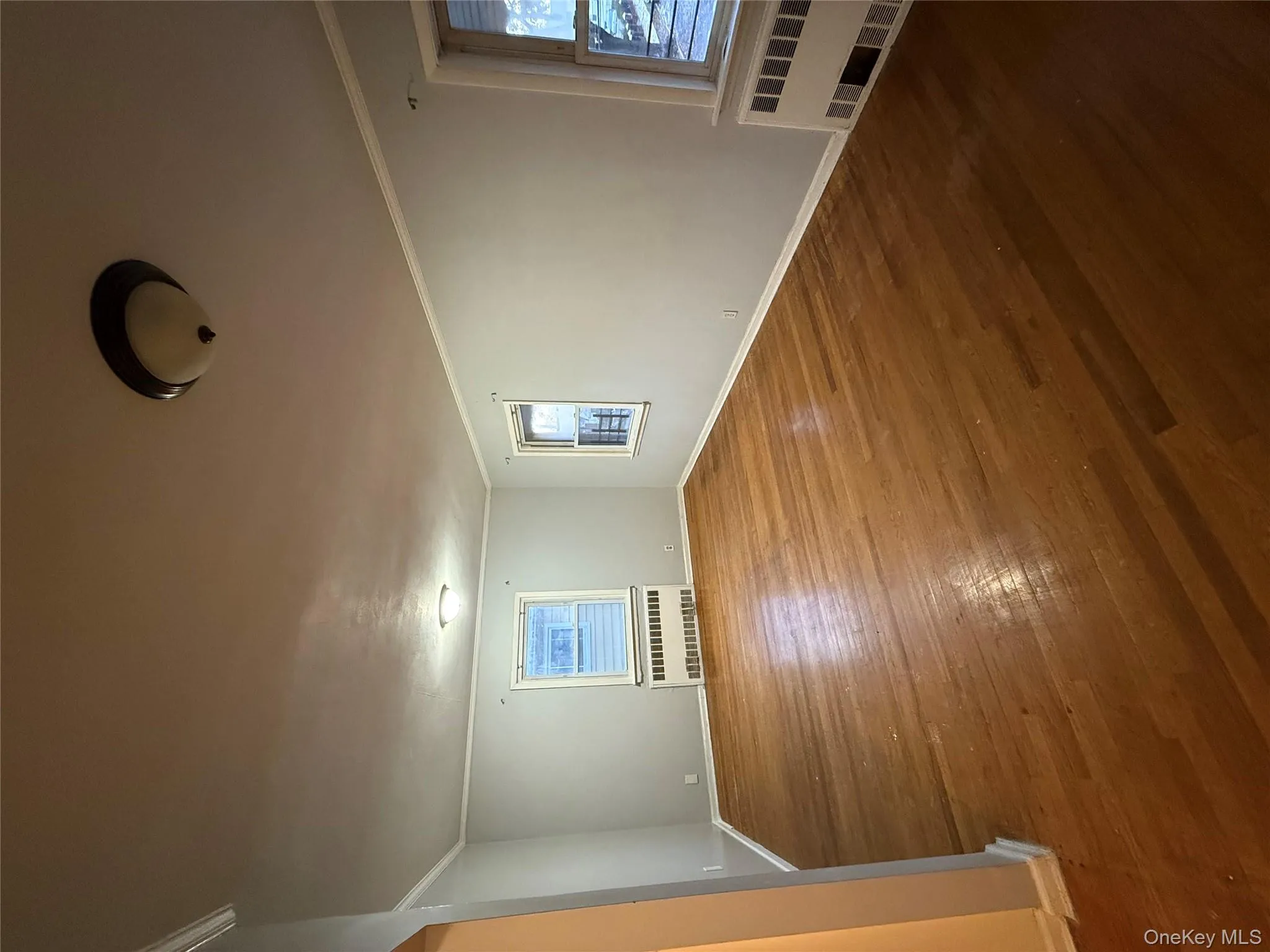 Unfurnished room featuring crown molding, radiator heating unit, and dark wood finished floors Unfurnished room featuring crown molding, radiator heating unit, and dark wood finished floors