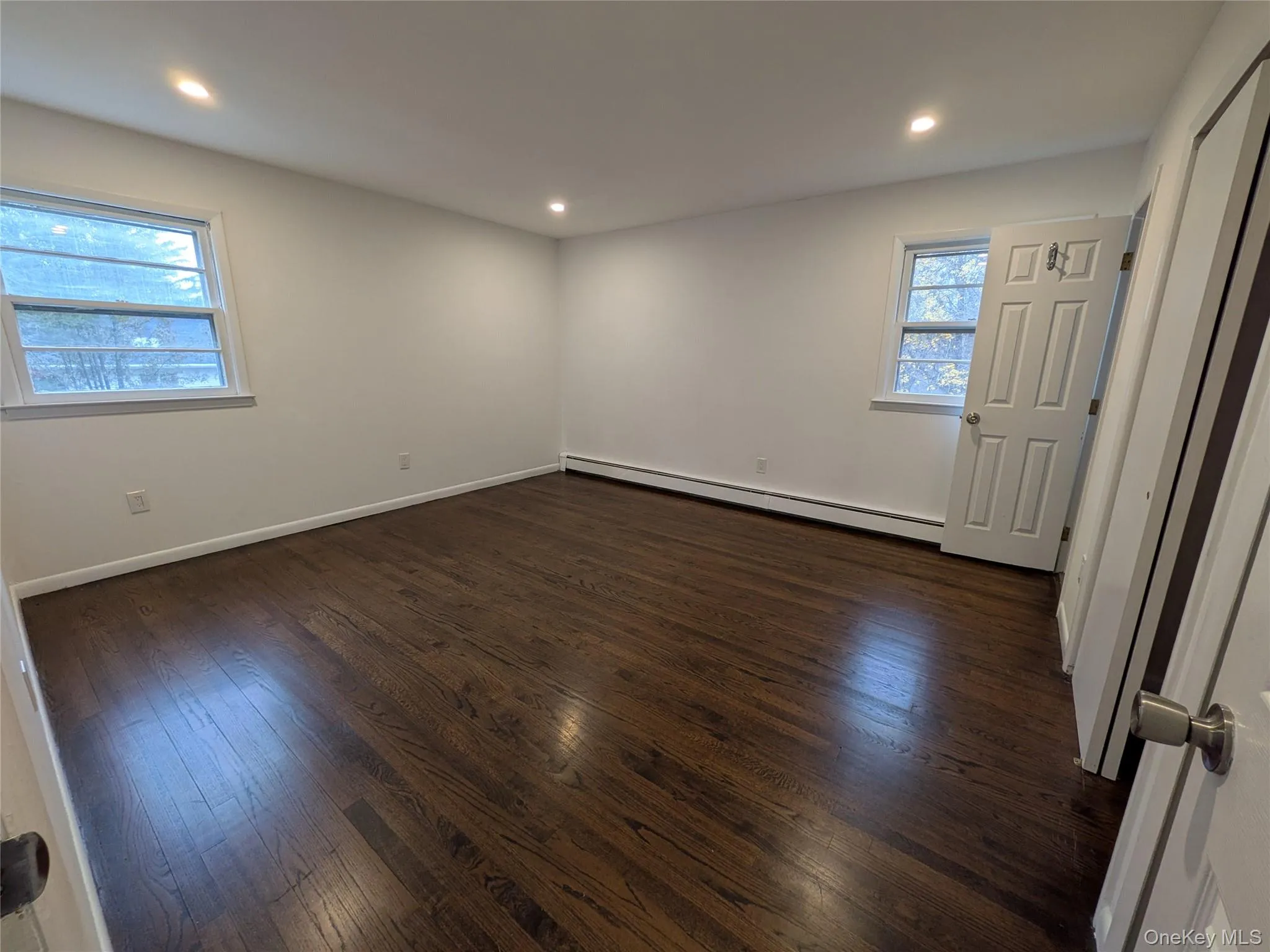 Primary Bedroom with dark stained hardwood floors, two double door closets and a primate full bathroom. Primary Bedroom with dark stained hardwood floors, two double door closets and a primate full bathroom.