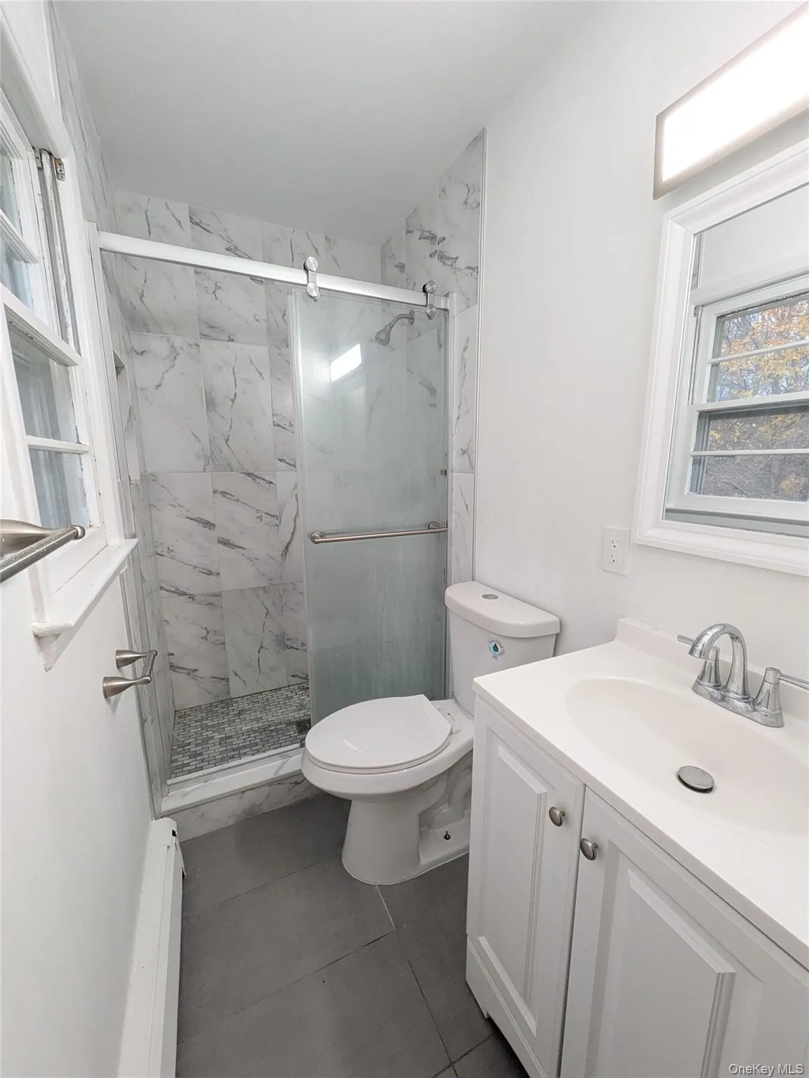 Primary Full bathroom with plenty of natural light, tiled shower with glass doors. Primary Full bathroom with plenty of natural light, tiled shower with glass doors.