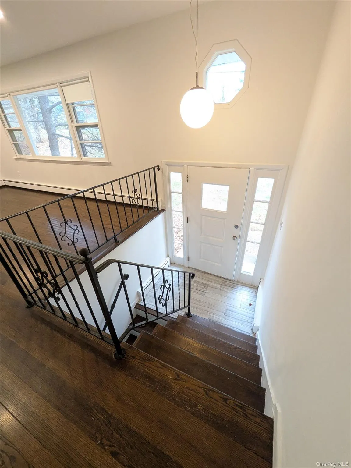 Staircase featuring a chandelier and a ceramic entry landing. Staircase featuring a chandelier and a ceramic entry landing.