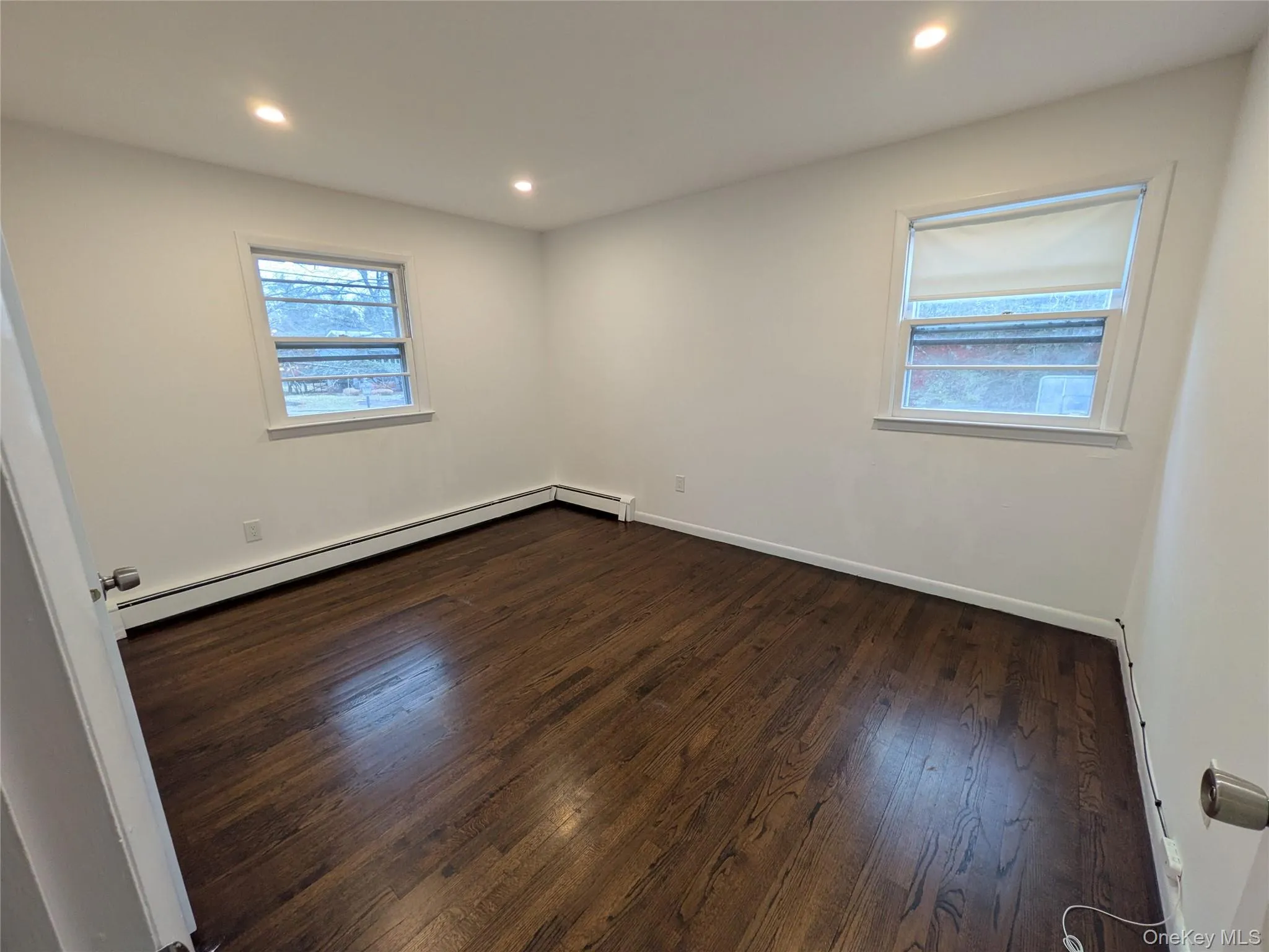 Living Room with dark stained hardwood floors, panoramic window and recessed lighting. Living Room with dark stained hardwood floors, panoramic window and recessed lighting.