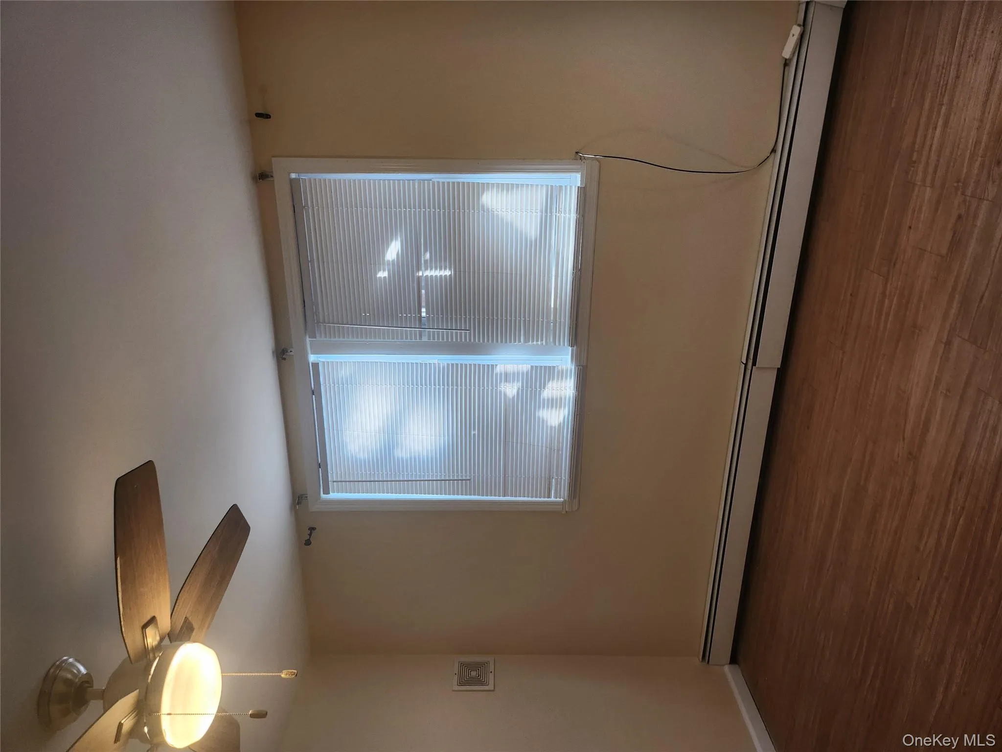 Spare room with a baseboard radiator, dark wood-type flooring, and a ceiling fan Spare room with a baseboard radiator, dark wood-type flooring, and a ceiling fan