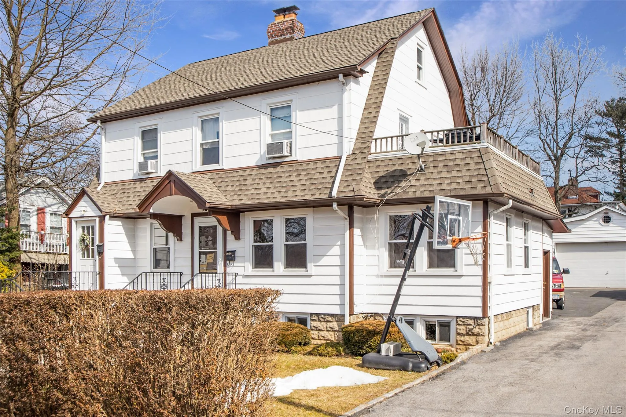 View of front of property with roof with shingles, a chimney, and a detached garage View of front of property with roof with shingles, a chimney, and a detached garage
