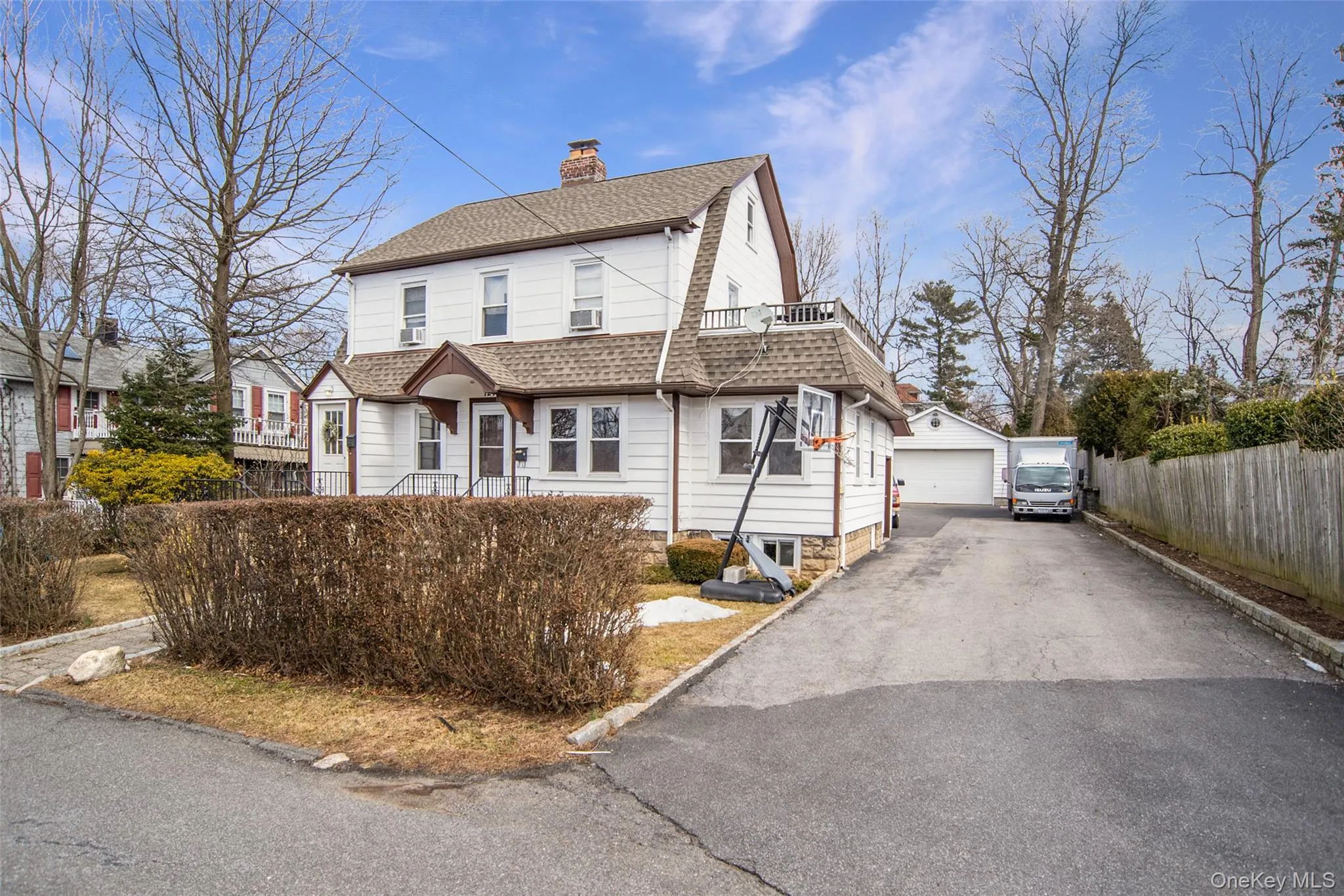 View of front of property with roof with shingles, a chimney, a detached garage, and an outdoor structure View of front of property with roof with shingles, a chimney, a detached garage, and an outdoor structure