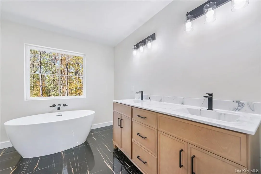 Bathroom featuring vanity and a bathtub Bathroom featuring vanity and a bathtub