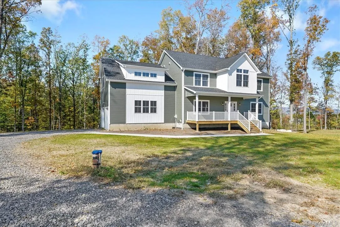 View of front of property featuring a front lawn and a porch View of front of property featuring a front lawn and a porch