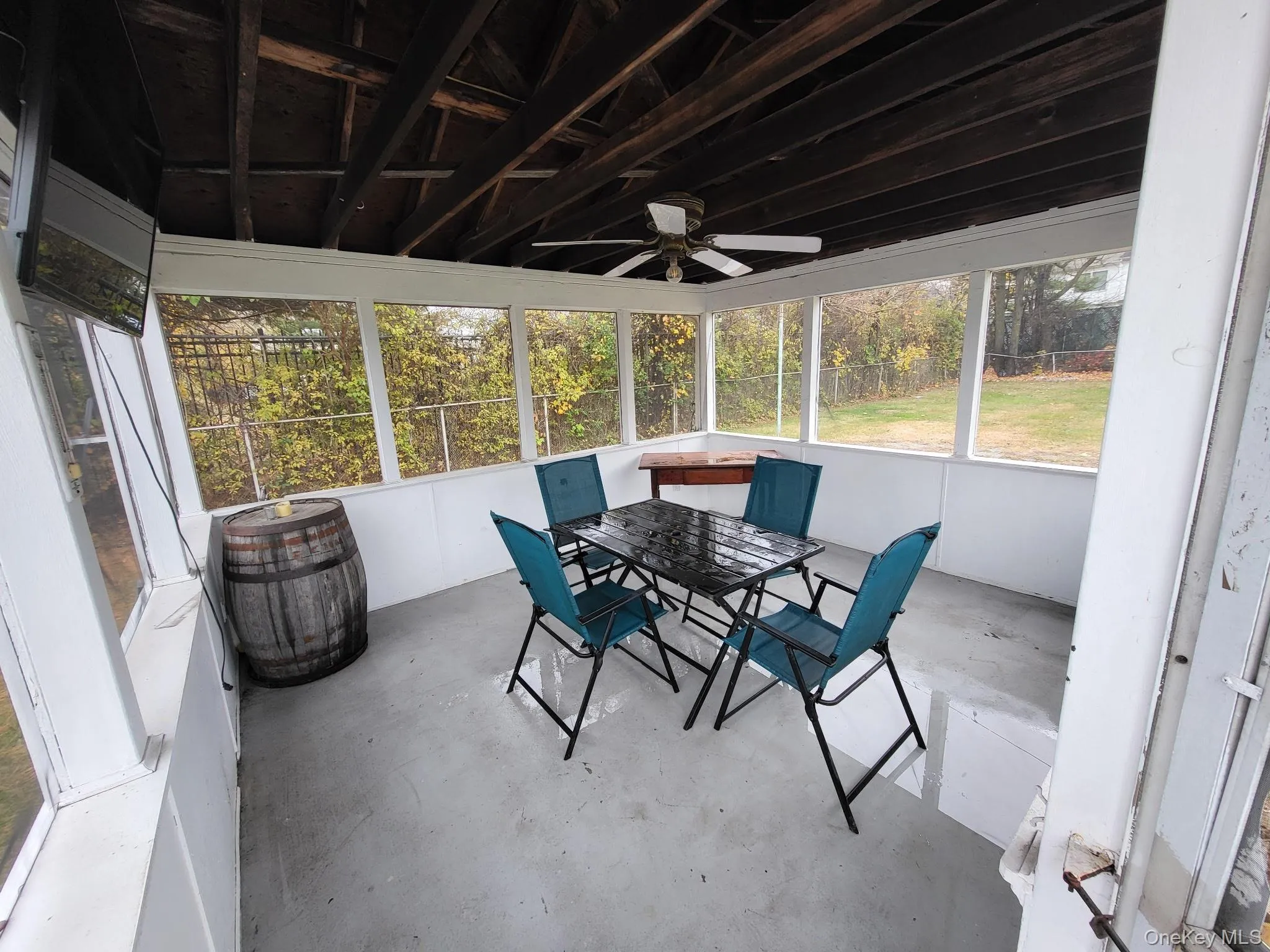 Sunroom / solarium featuring outdoor dining area and a ceiling fan Sunroom / solarium featuring outdoor dining area and a ceiling fan