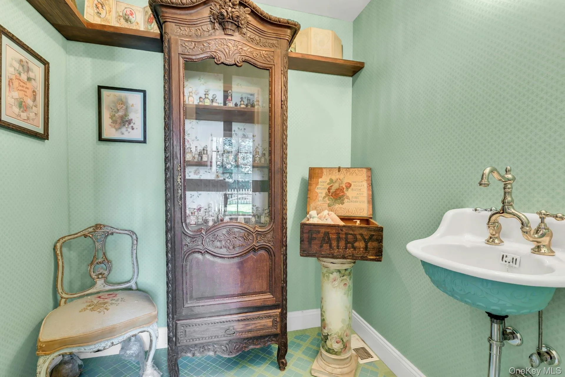 Staged Half bathroom featuring wallpapered walls and antique sink Staged Half bathroom featuring wallpapered walls and antique sink