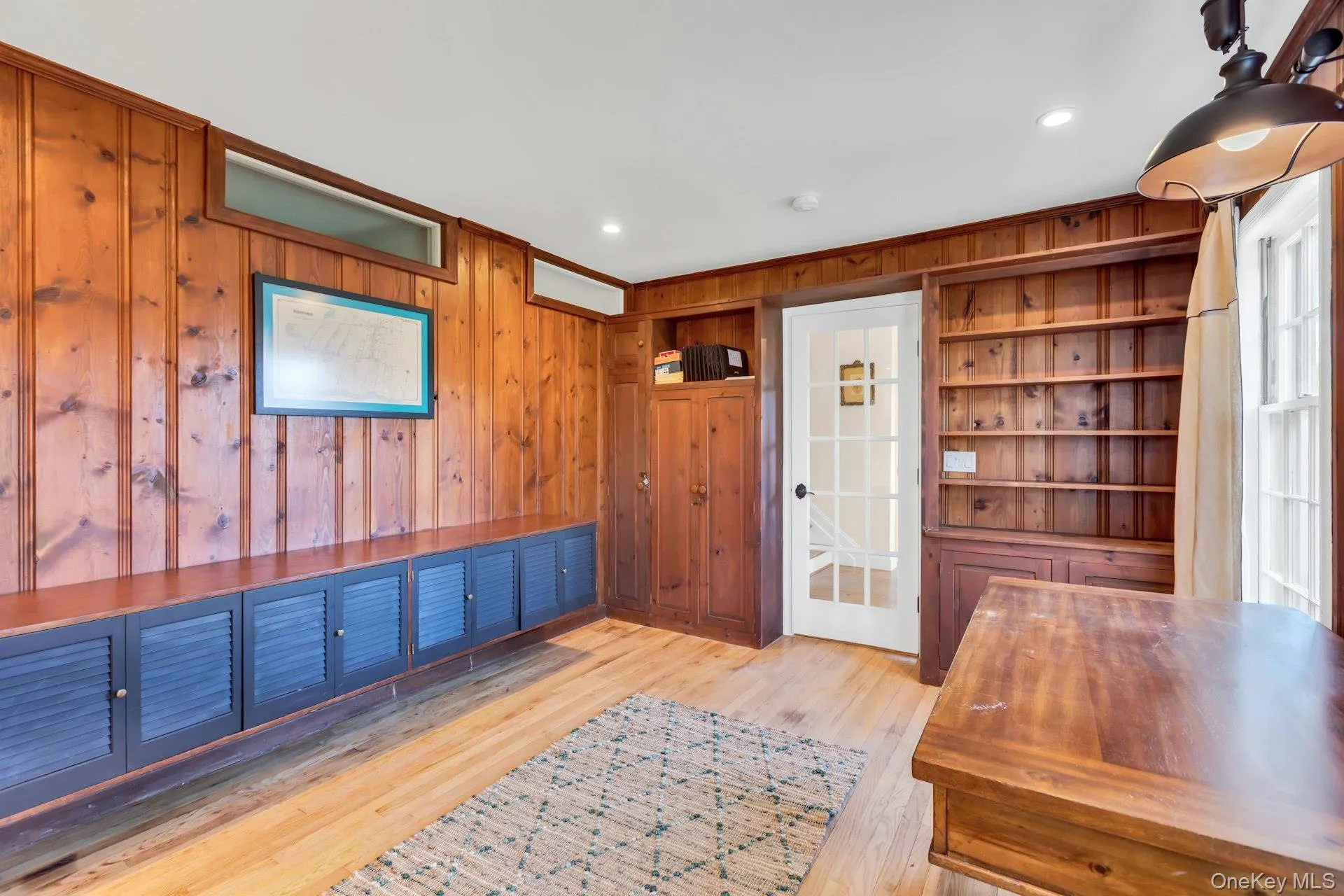 Office space featuring wooden walls, light wood finished floors, and recessed lighting Office space featuring wooden walls, light wood finished floors, and recessed lighting