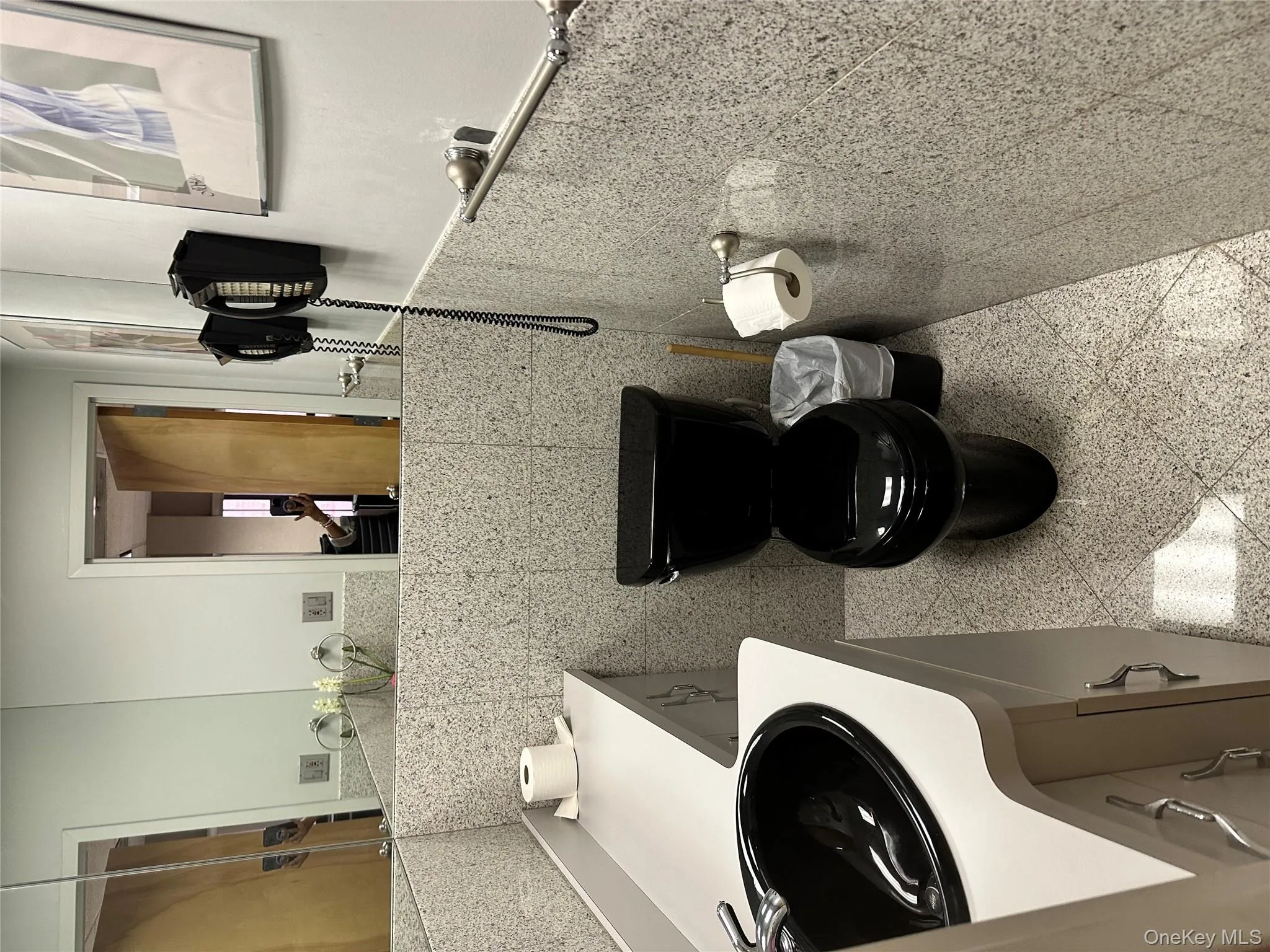 Half bathroom featuring vanity and tile walls Half bathroom featuring vanity and tile walls