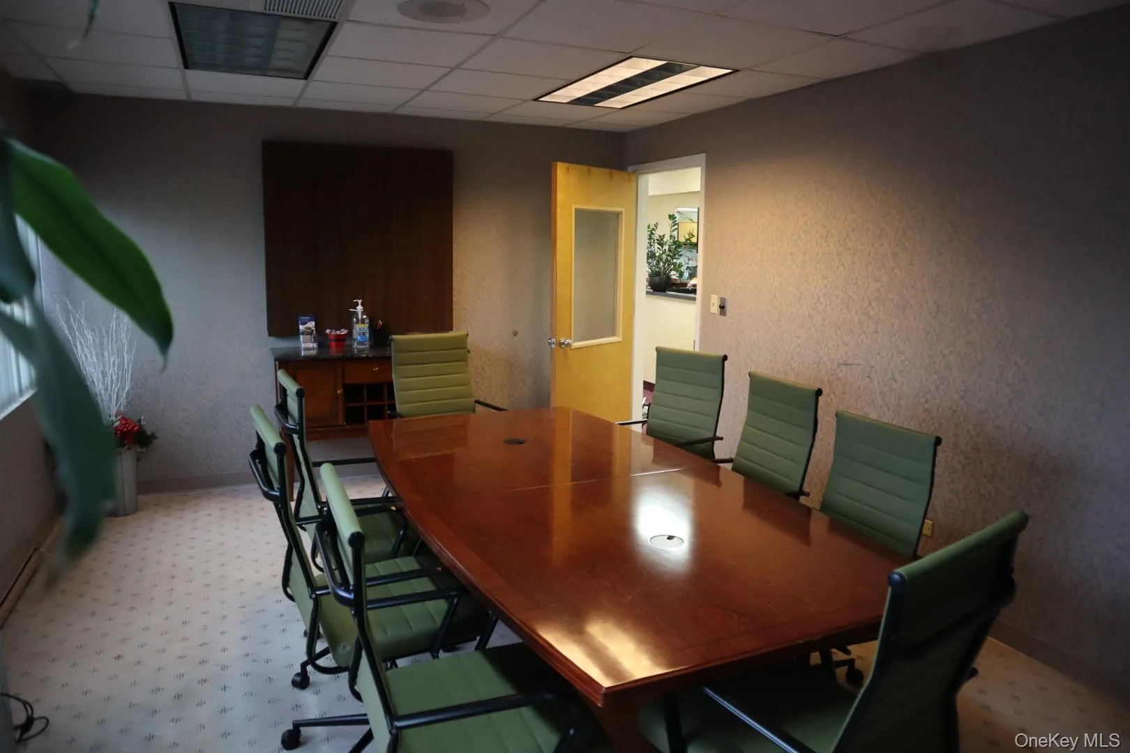 Conference room with a paneled ceiling and a textured wall Conference room with a paneled ceiling and a textured wall
