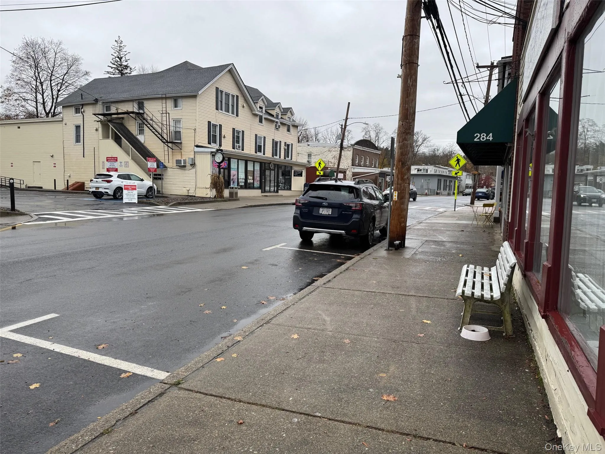View of asphalt road with traffic signs, curbs, and sidewalks View of asphalt road with traffic signs, curbs, and sidewalks