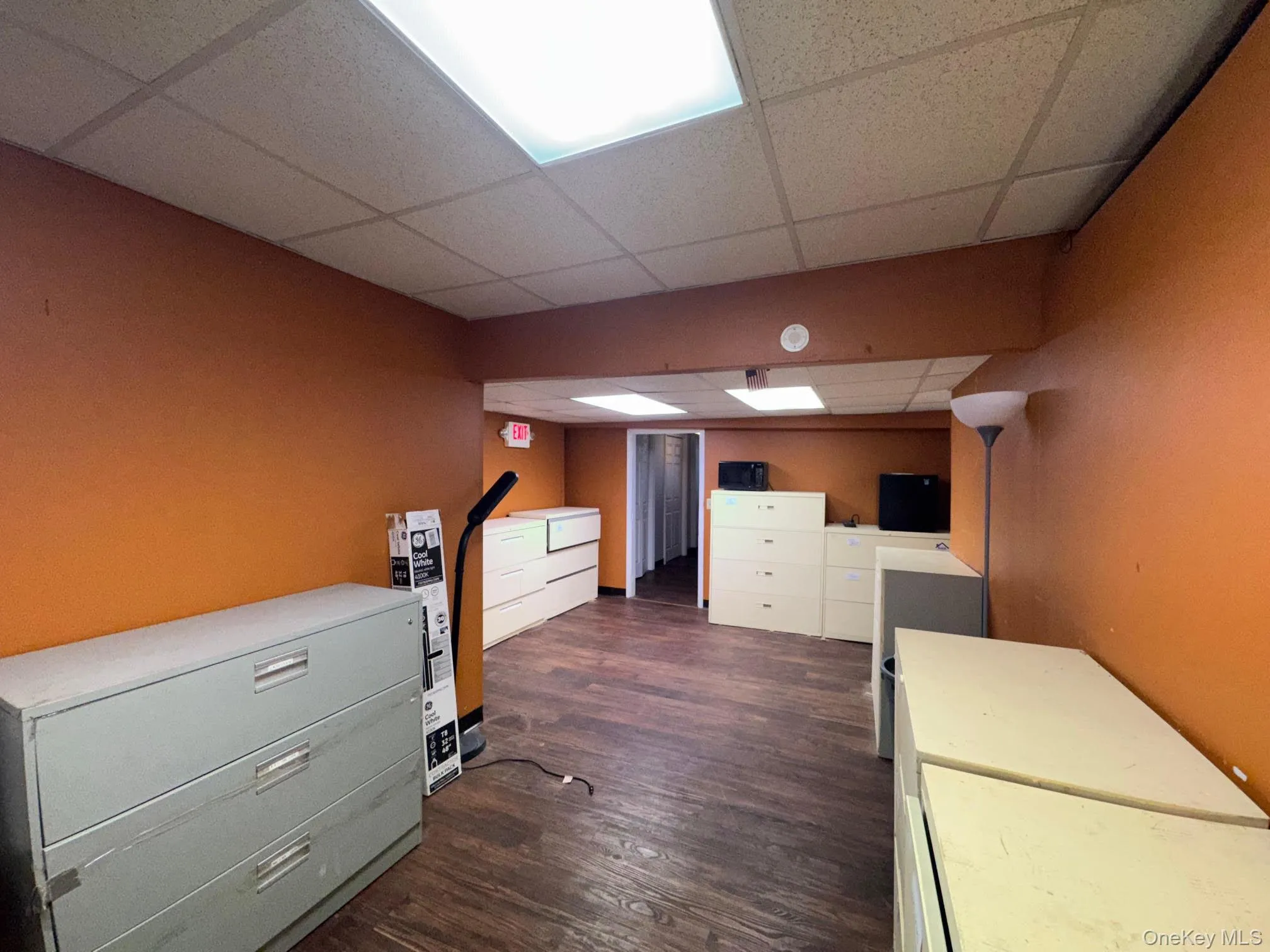 Office featuring a drop ceiling and dark wood finished floors Office featuring a drop ceiling and dark wood finished floors