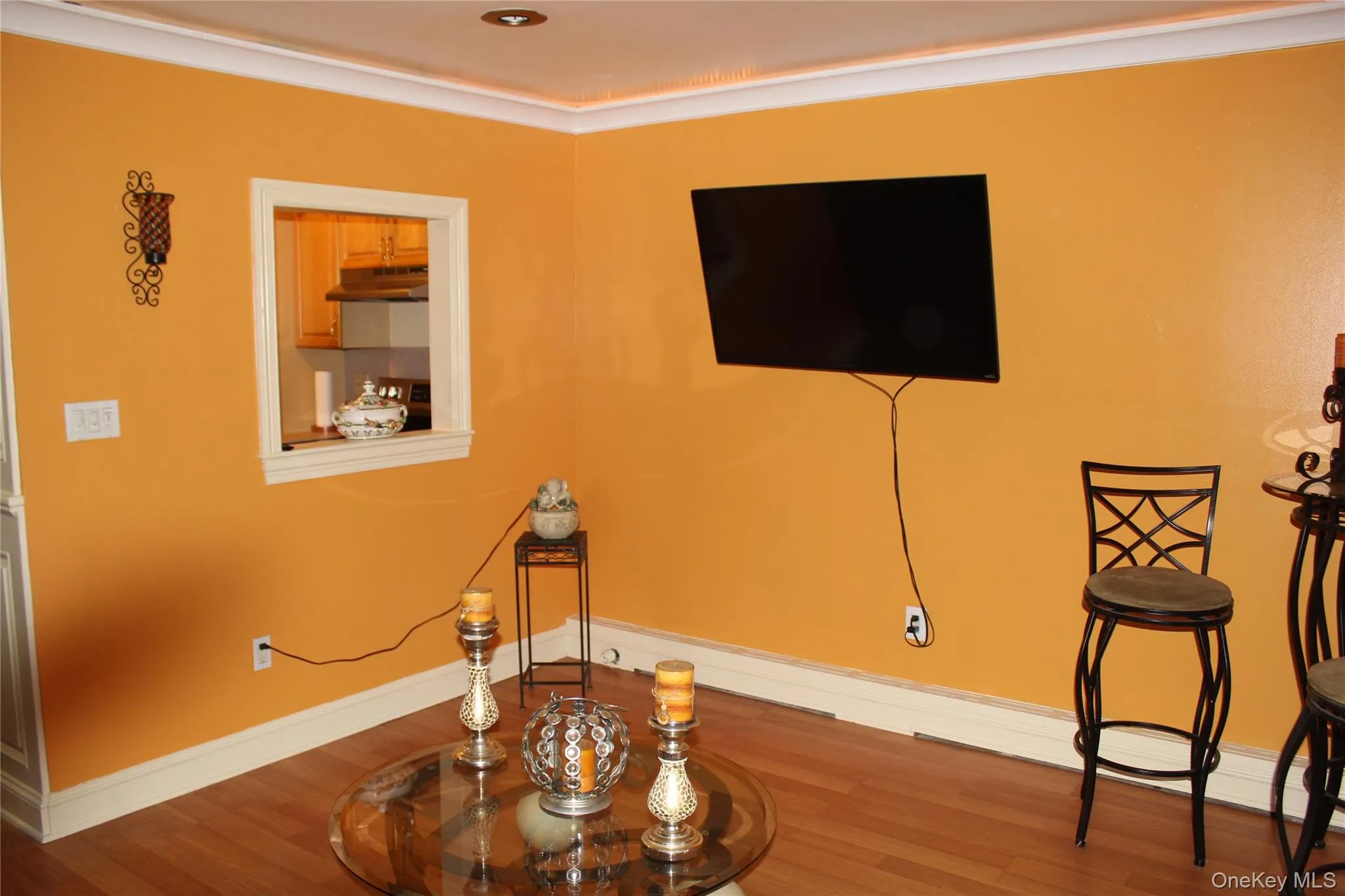 Living area with baseboards and wood finished floors Living area with baseboards and wood finished floors