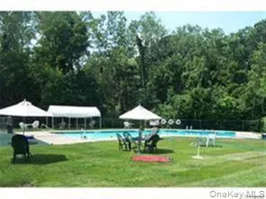 View of property's community featuring a pool, a lawn, a gazebo, and a patio area View of property's community featuring a pool, a lawn, a gazebo, and a patio area