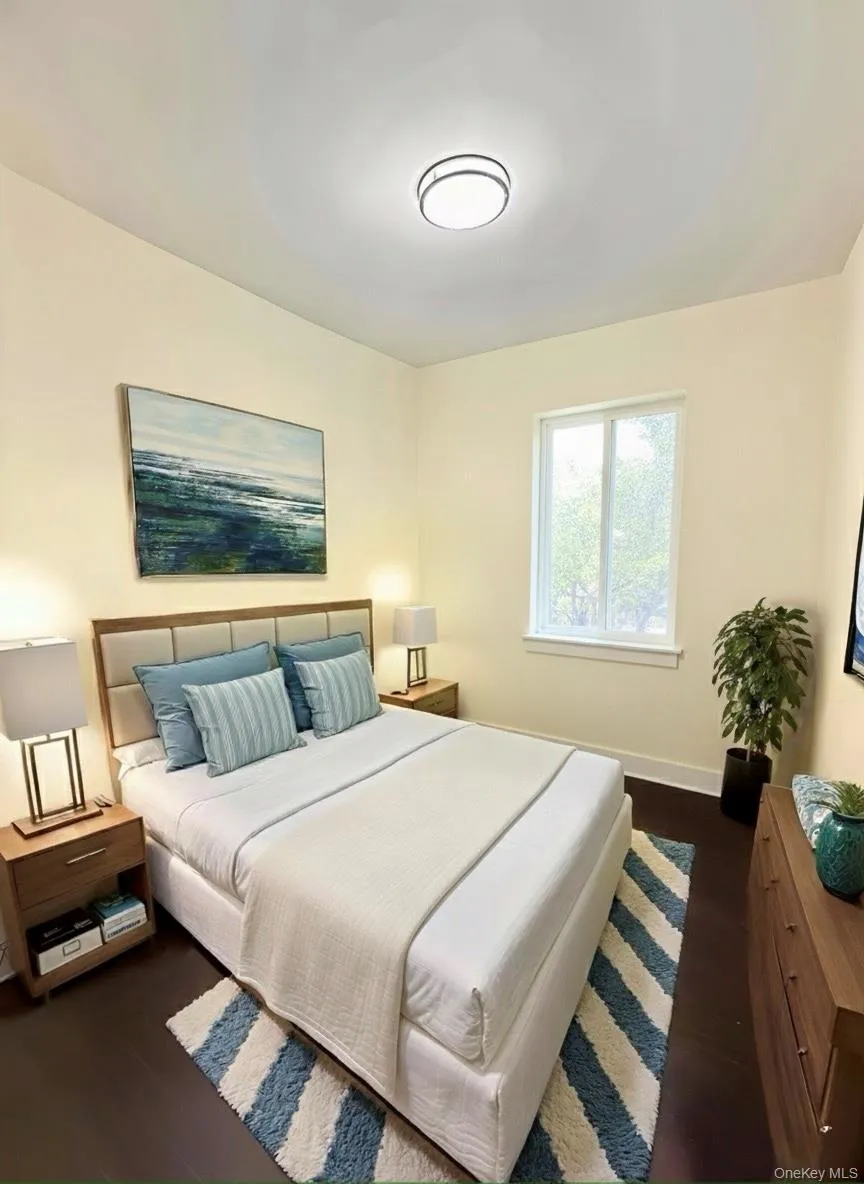 Bedroom with dark wood-style flooring and baseboards Bedroom with dark wood-style flooring and baseboards