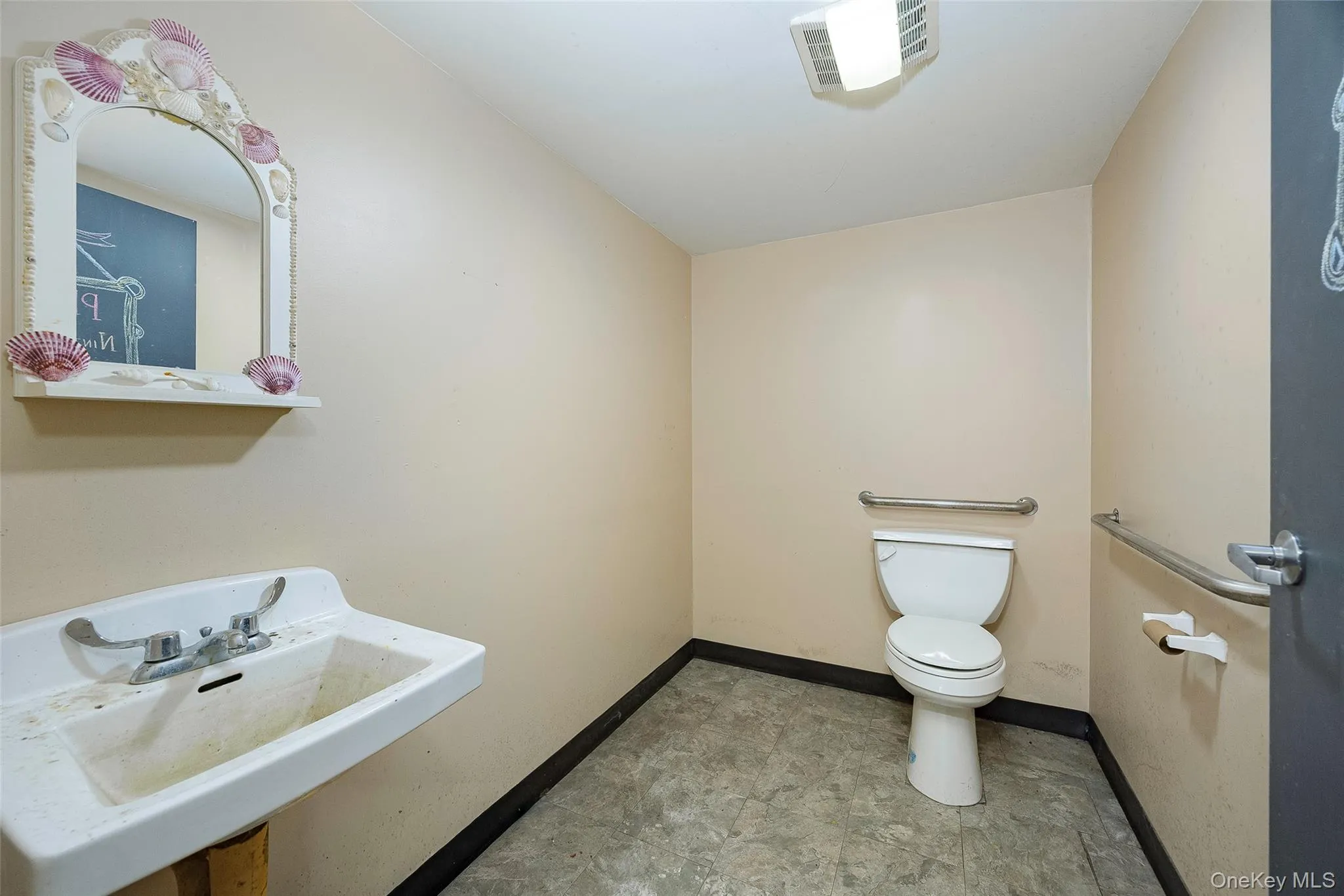 Half bath featuring toilet and baseboards Half bath featuring toilet and baseboards