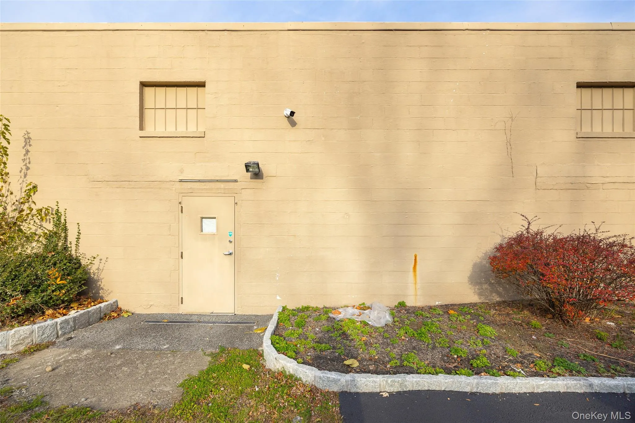 View of exterior entry featuring concrete block siding View of exterior entry featuring concrete block siding