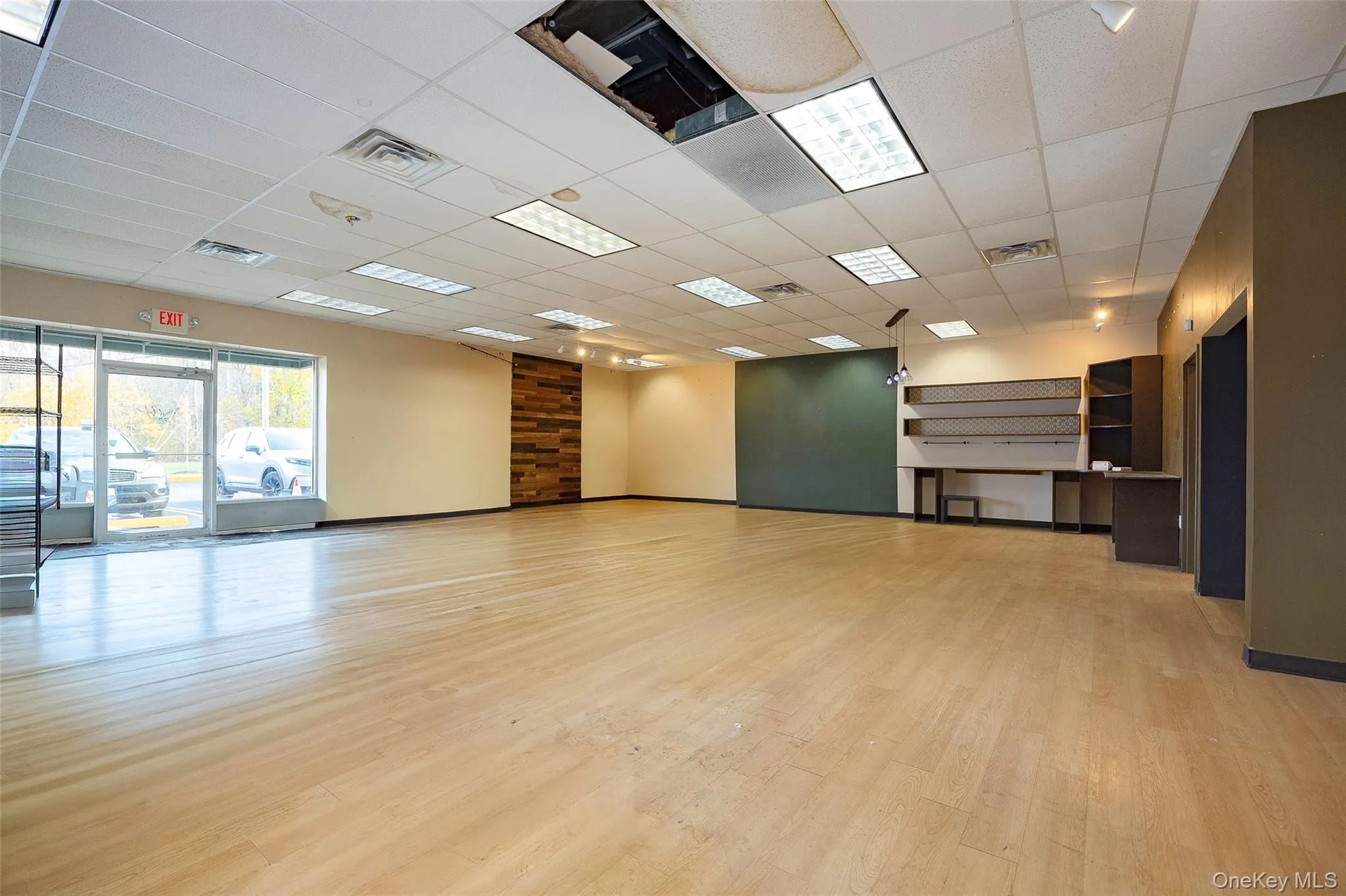 Empty room featuring a paneled ceiling and light wood-style floors Empty room featuring a paneled ceiling and light wood-style floors