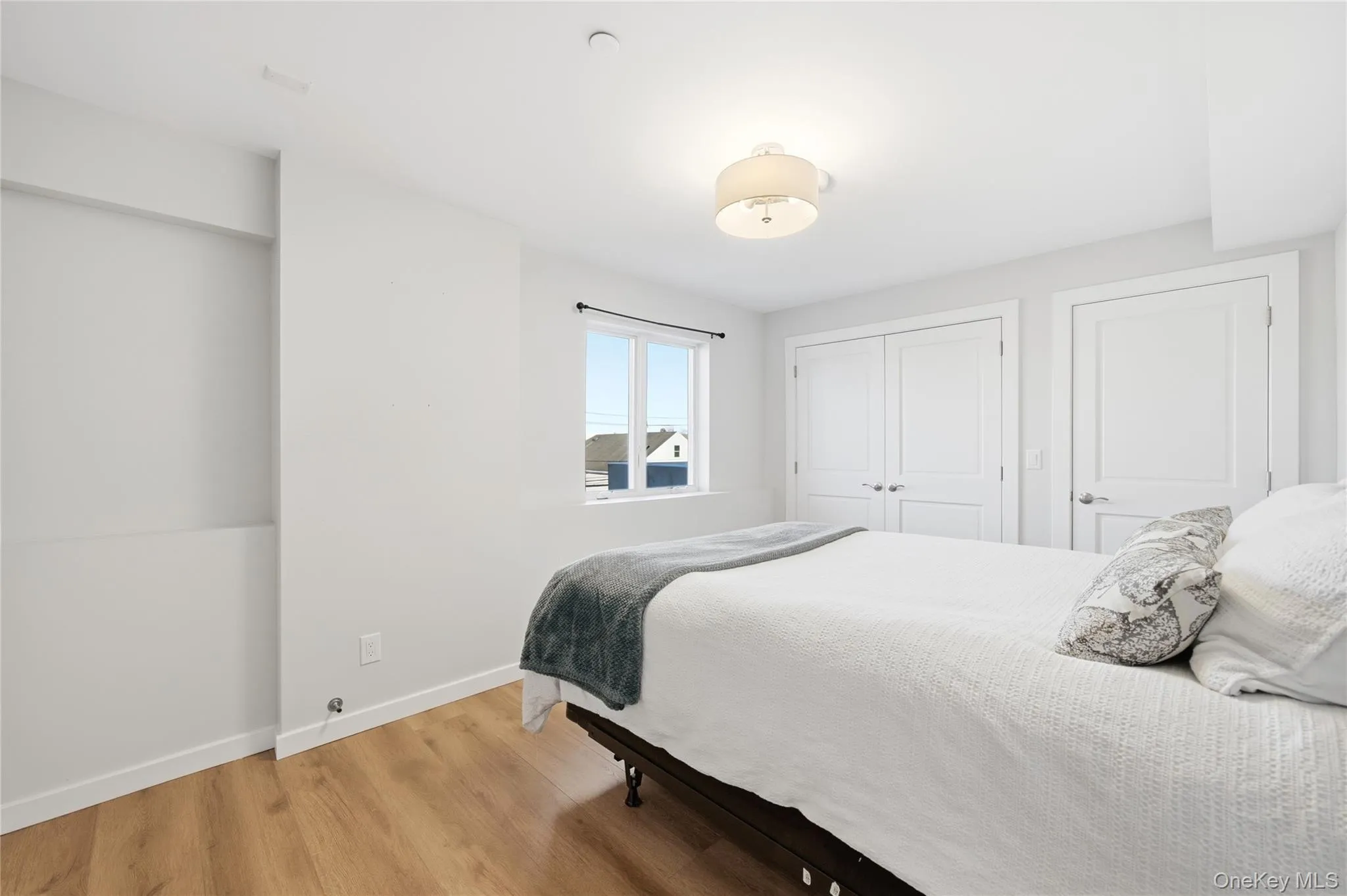 Bedroom with light wood-type flooring and a closet Bedroom with light wood-type flooring and a closet