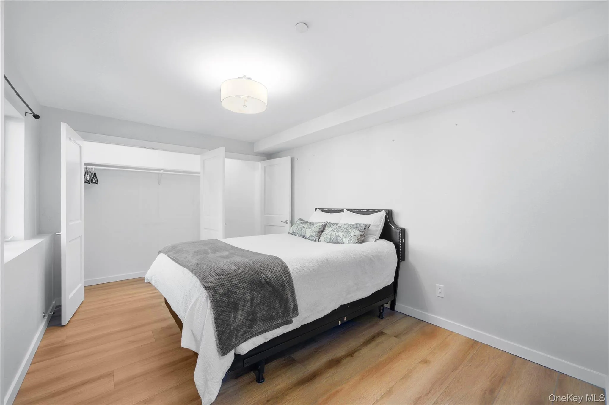 Bedroom featuring light wood-type flooring and a closet Bedroom featuring light wood-type flooring and a closet